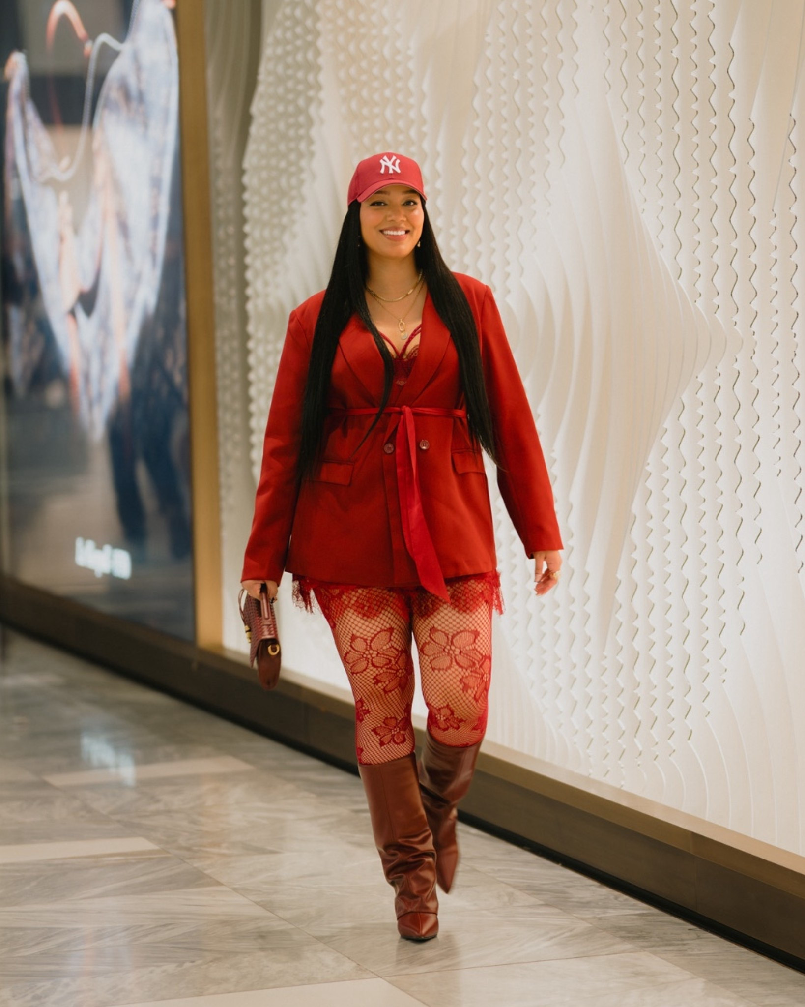 Oversized red blazer layered over a lace slip dress, paired with bold red floral tights and knee-high leather boots. Topped it off with a red NY cap for that sporty-chic contrast and a textured burgundy clutch to break up the tones just right.

#LTKTall #LTKootd #LTKMidsize