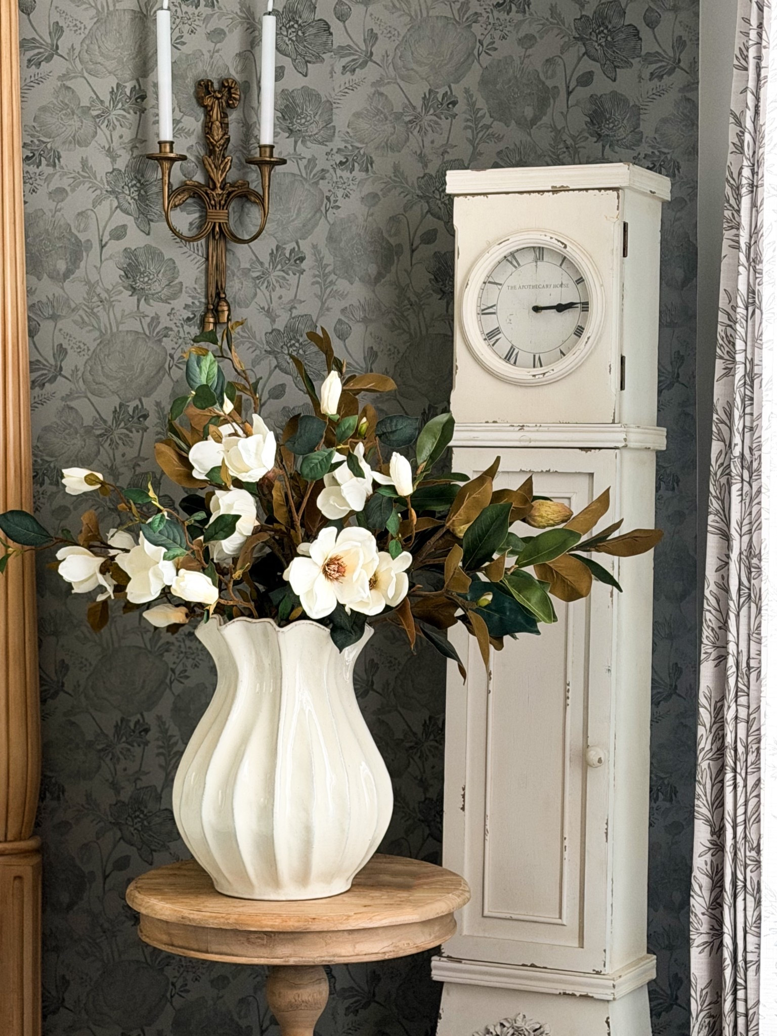 Spring magnolias around the house.

One thing I love about decorating with faux florals is how easy they are to move from room to room. These magnolia stems from @afloral have that classic Southern garden look that instantly makes a space feel like spring.

Instead of treating them like a perfect arrangement, I style them the same way I would fresh branches from the yard. A few stems leaning outward, a few blooms sitting lower, & letting the leaves turn naturally so you see those beautiful deep greens & warm bronze tones.

Magnolias have such a timeless presence. Whether they’re sitting on a coffee table, dining table, or entry table, they bring that soft seasonal shift into the home without feeling overly styled.

Sometimes it really is as simple as a vase and a few good stems.

#afloral #homedecor #interiordesign #luxuryliving #fauxreal 