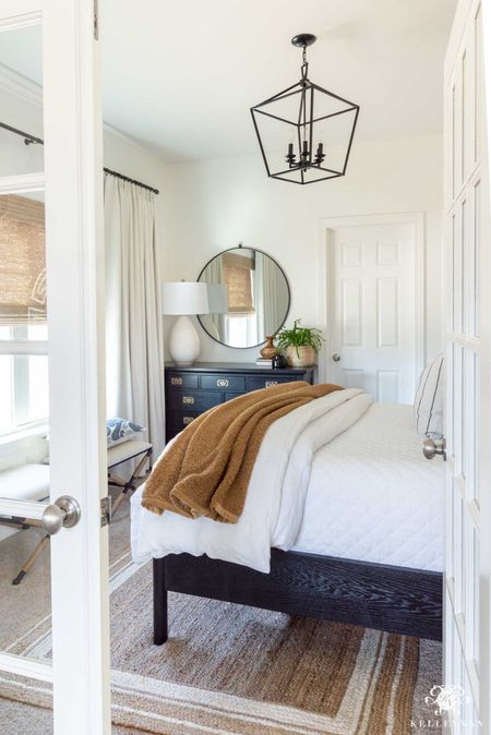 I like to make guests comfortable in our blue and white guest room with the best bedding, these x stools for their suitcase or sitting and this round mirror they can use for getting ready. Home decor bedroom decor white bedding lantern chandelier black dresser teddy bear throw

#LTKstyletip #LTKhome