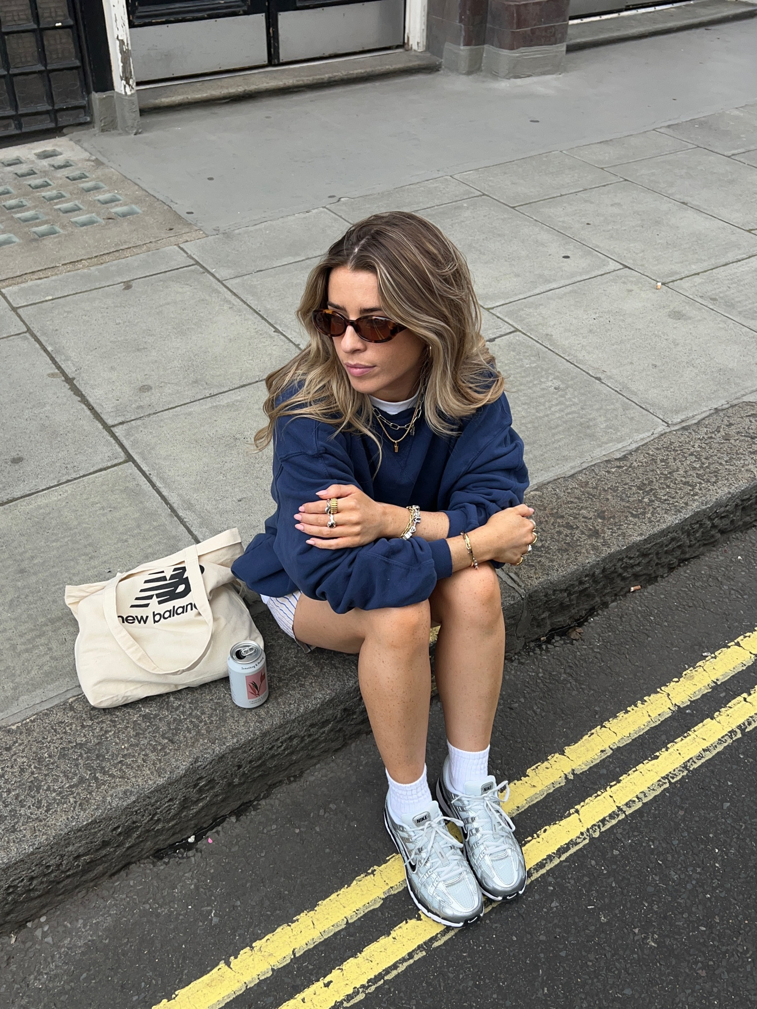 Blue sweatshirt, shorts, white trainers, black sunglasses, tote bag, jewellery 

#LTKSeasonal #LTKeurope #LTKstyletip