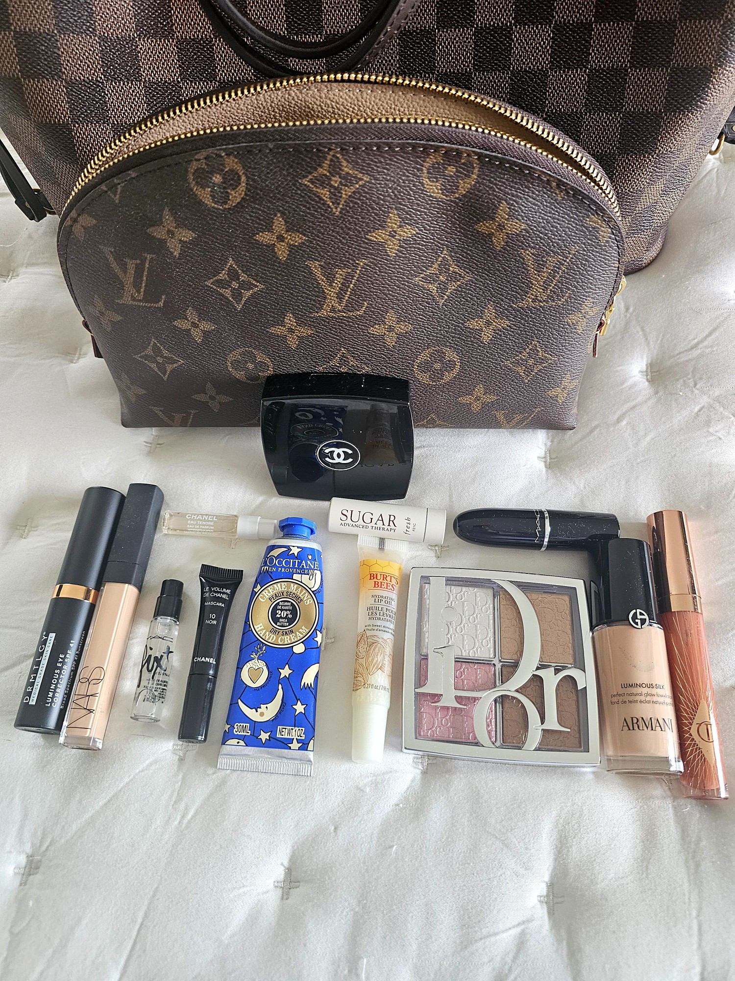 What’s currently in my tote makeup bag? 👜✨

A little peek inside my everyday beauty bag -  an edited collection of products I genuinely love and find myself reaching for when on the go. 🤍

✨ Armani Luminous Silk Foundation — for that beautiful, natural-looking luminous finish
✨ NARS concealer — for quick complexion touch-ups
✨ DRMTLGY Luminous Eye Color Corrector — one of my favorite ways to brighten the under-eye area
✨ Dior palette — eyes, cheeks & glow in one gorgeous compact
✨ Chanel Powder Blush in Rose Pétale — a soft, flattering flush that works beautifully with a natural makeup look
✨ Chanel Le Volume Mascara (mini) — a longtime favorite and a staple in my kit
✨ Charlotte Tilbury Pillow Talk Lip Gloss — an easy swipe when I want a polished, effortless lip
✨ MAC Lipstick in Sellout — one of those beautiful everyday shades that just works
✨ MAC Fix+ Setting Spray (mini) — my mini for refreshing and setting makeup throughout the day
✨ Chanel Chance Eau Tendre (mini)  — my favorite fragrance
✨ L’Occitane Shea Butter Hand Cream — because hydrated hands are always a necessity
✨ Burt’s Bees Lip Balm & Sugar Balm — I like lip choices! :)

Not my full personal makeup bag at home - just the little edit of beauty products I like to keep close.

Apparently, even my “edited” makeup bag still requires its own tote. 😂👜 

 #LTKdayinmylife #LTKOver40 #LTKBeauty