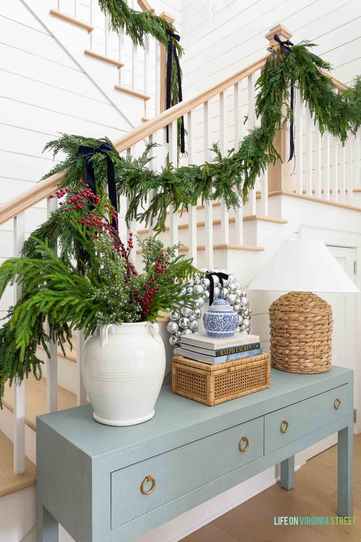 Christmas coastal home entryway // holiday decor for a coastal home // garland // console table  

 #LTKHoliday #LTKSeasonal #LTKHome