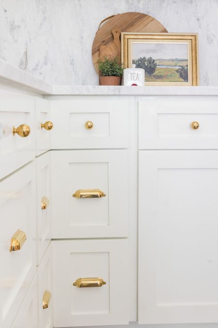Unlacquered brass kitchen cabinet hardware. Love how brass warms up a white space  

#LTKhome #LTKstyletip