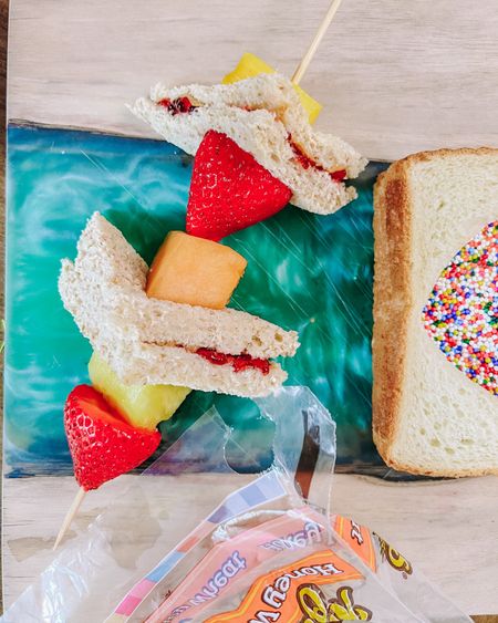 #AD school is back in session and Cami has been so excited to see what the next PB&J creation is going to appear in her lunch! @Target has come in clutch with everything I need to make the best sandwiches with my favorite peanut butter @skippybrand and bread @naturesownbread. They have everything I need to make PB&J kabobs!

Making them was super easy. I Took 2 slices of bread and cut them into smaller triangles. Then I made traditional PB&Js on the triangle slices. On a skewer I added pieces of Cami’s favorite fruit. In between the fruit pieces I pierced through the mini sandwiches with the skewer. And just like that, something fun and different from her regular lunch! Pro tip: Wrap the skewer in saran wrap before putting it in your kids’ lunch box.

Find everything you need for your next PB&J “elevation” in my LTK shop, you can shop directly from there!
#Target, #TargetPartner, #brunch, #peanutbutter, #pb, #tasty, #easysnack, and #schoolsnack


#LTKfamily #LTKhome #LTKkids
