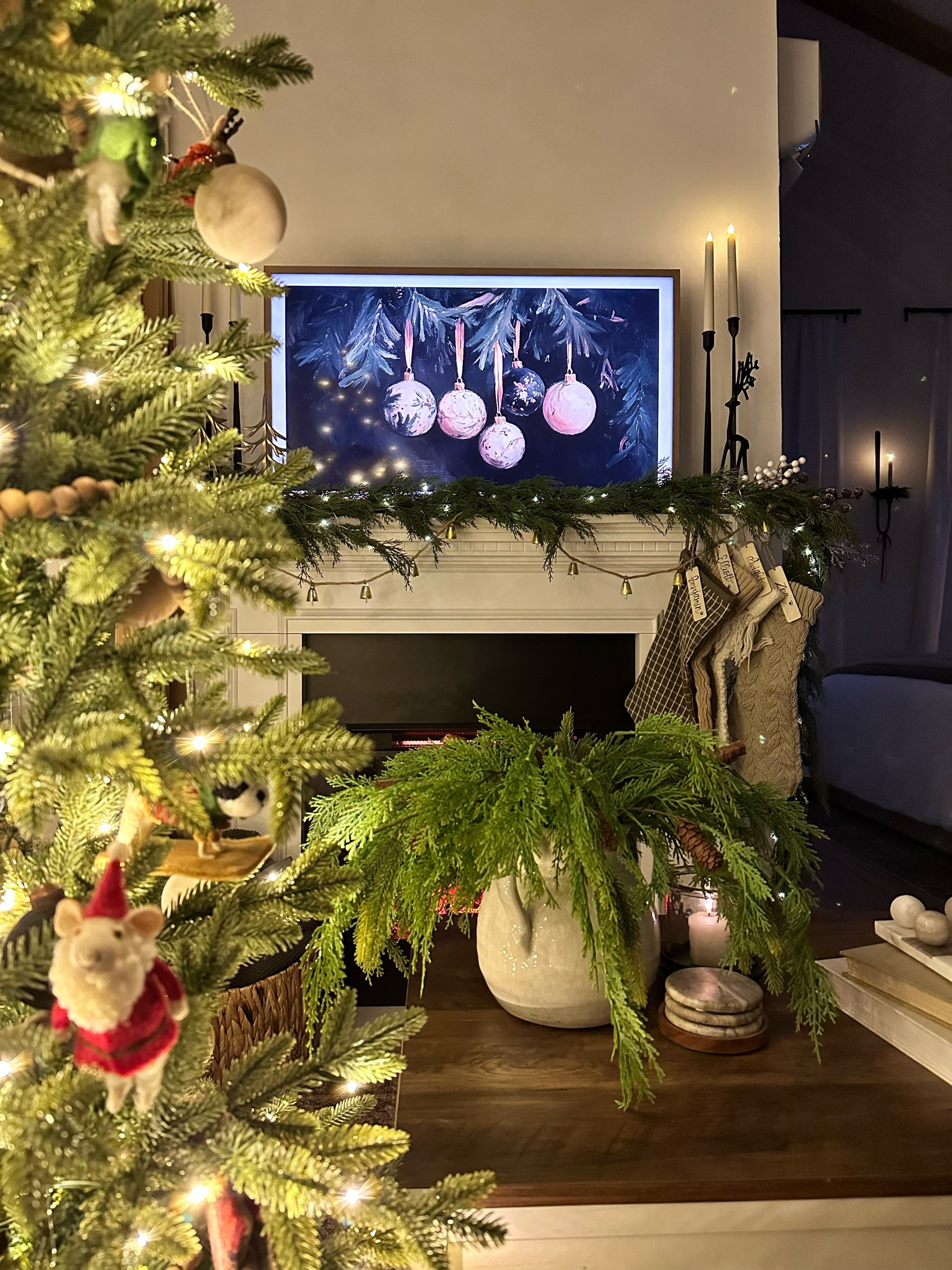 Christmas decor with beautiful garland, flameless candles, and a cozy electric fireplace. Perfect for watching Hallmark movies! 

#LTKHoliday #LTKHome