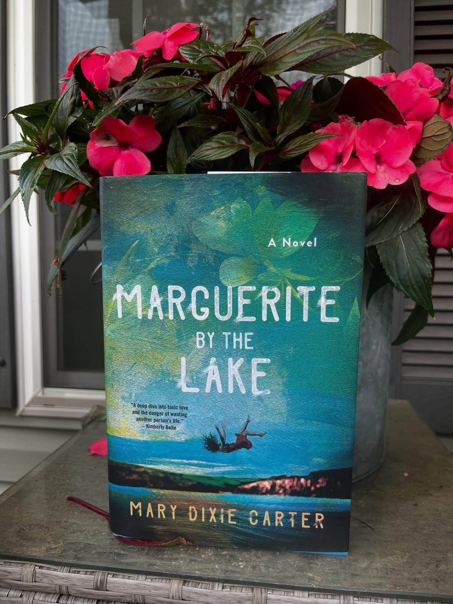 Book Spotlight 
Marguerite by the Lake
By: Mary Dixie Carter 

Thanks @marydixiecarter @minotaur_books and @tlcbooktours for the #gifted copy! 

Synopsis: 
“Marguerite Gray is a lifestyle icon known for her garden parties, high-end business ventures, and being the muse behind the famous Serge Kuhnert painting, Marguerite by the Lake. Her presence is overpowering, her taste, legendary. For the last few years, Phoenix has been the gardener on the famed Rosecliff grounds, home of the Gray family: Marguerite and her husband Geoffrey. Phoenix came from humble beginnings, and now she works hard to craft the landscape that underpins Marguerite’s brand.
When a storm threatens the launch party for Marguerite’s latest book, it’s Phoenix who spots the danger to the guests and rushes to Geoffrey’s side to save him from a falling tree. Geoffrey is grateful–perhaps too grateful. Marguerite is . . . jealous. Phoenix senses the danger of being drawn deeper into their lives but can’t resist the attention, becoming embroiled in an affair that could destroy her career.
But soon after the affair begins Marguerite falls to her death, from the same high point at Rosecliff where she posed for Marguerite by the Lake. Now Phoenix has another secret, one that haunts her even as Geoffrey invites her to move into the manor with him. A secret that Detective Hanna and Marguerite’s daughter–her spitting image–are circling closer and closer to. Phoenix tries to put it all behind her and find her rightful place at Rosecliff. But as every gardener knows, nothing stays buried forever.”

This one sounds a little spookier than my usually reads, but excited to try it. The garden atmosphere and cliff side house are a totally vibe. 

Are you a gardener? I love the idea, but am not so great at keeping the plants alive. 

#bookmail #bookishmail #tbr #bookish  #newrelease #newbookalert #gifted 
#MargueriteByTheLake #MaryDixieCarter