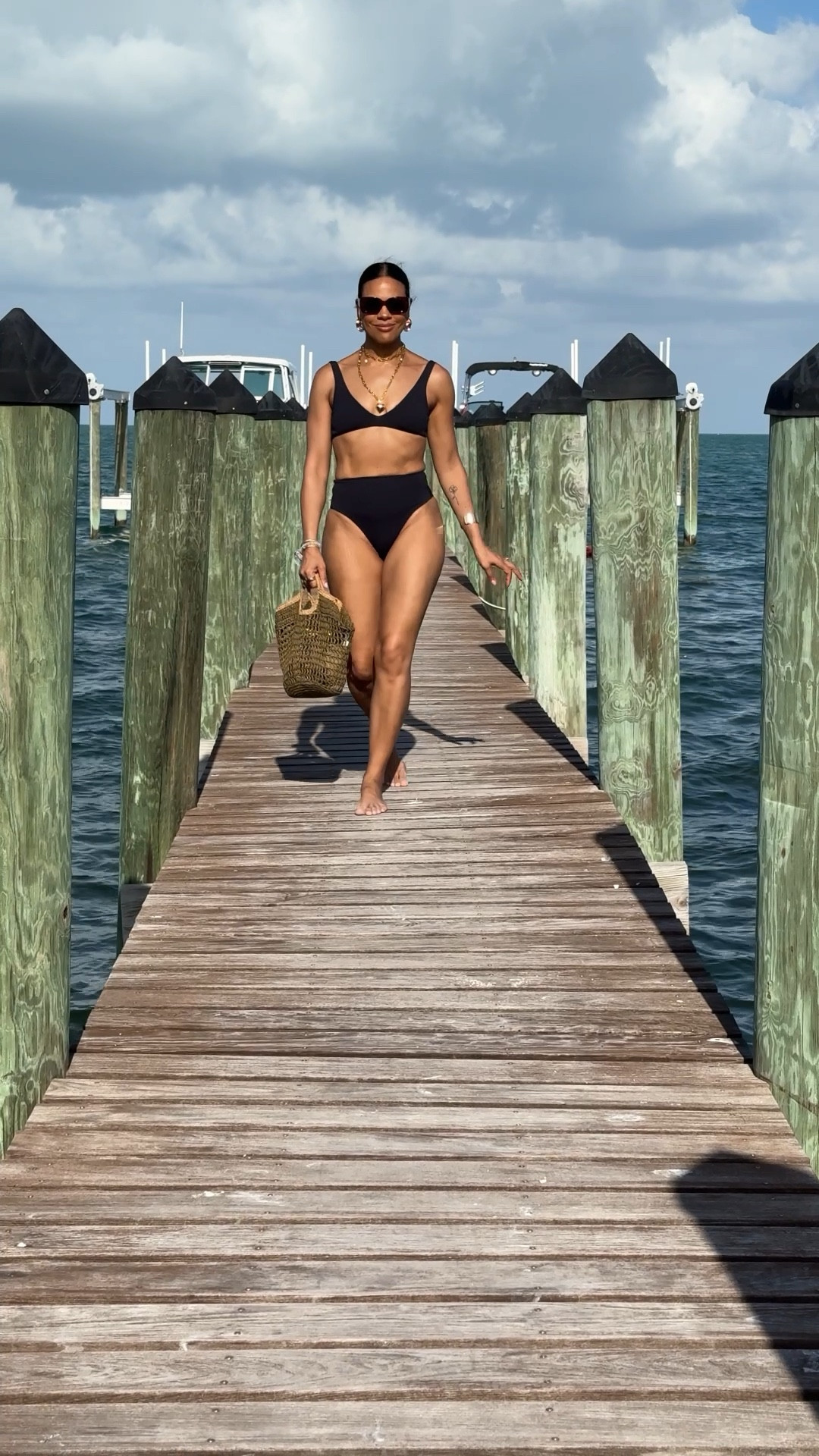 Beach OOTD: two piece black bikini, v neck bikini top, high waisted bikini bottoms, gold accessories, lined tote bag, oversized red sunglasses. 

#LTKSwim #LTKOver40 #LTKStyleTip