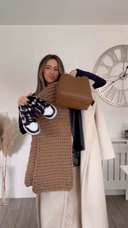 Cosy winter outfit, black faux leather trousers, black knitted jumper, oversized cream coat, tan chunky scarf, tan bag. 

#LTKstyletip #LTKeurope #LTKSeasonal