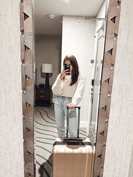 Travel outfit with neutral sweater, light wash jeans, and neutral luggage 

#LTKunder100 #LTKFind #LTKtravel
