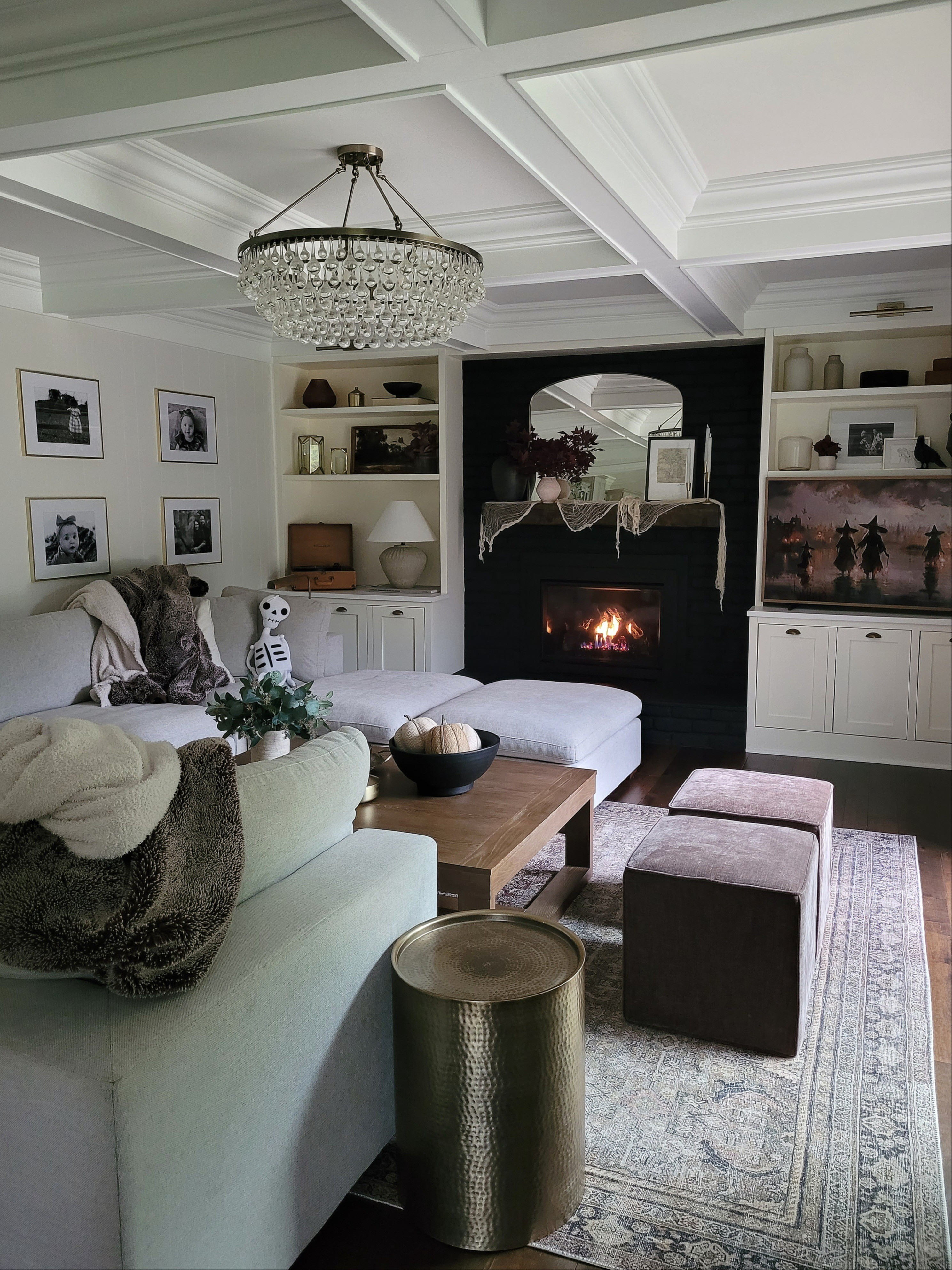 Spooky Halloween living room and family room decor - the black fireplace is so fun to decorate this time of year! spooky mantle,  shelf styling,  Halloween decor, coffee table, Halloween fireplace,  ottomans, gallery wall

#LTKHome #LTKHalloween #LTKFindsUnder50