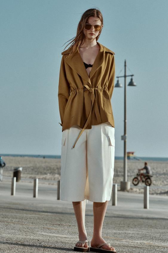 Trench-style jacket made with linen. Lapel collar and long sleeves with tab and button. Front wel... | Zara US