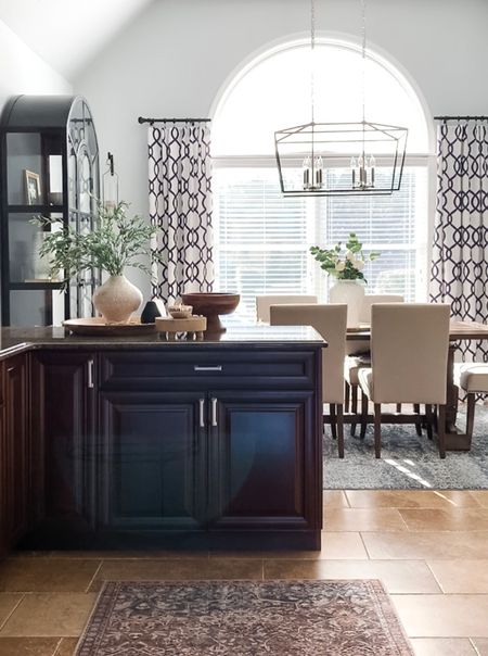Kitchen, dining room styling! Area rug, black glass display cabinet, trays for styling, dining room table, side chairs, elegant chandelier, window panels, curtains, textured vase, greenery stems, wood pedestal bowl. Home decor accessories, interior styling, design. 

#LTKFind #LTKhome #LTKstyletip