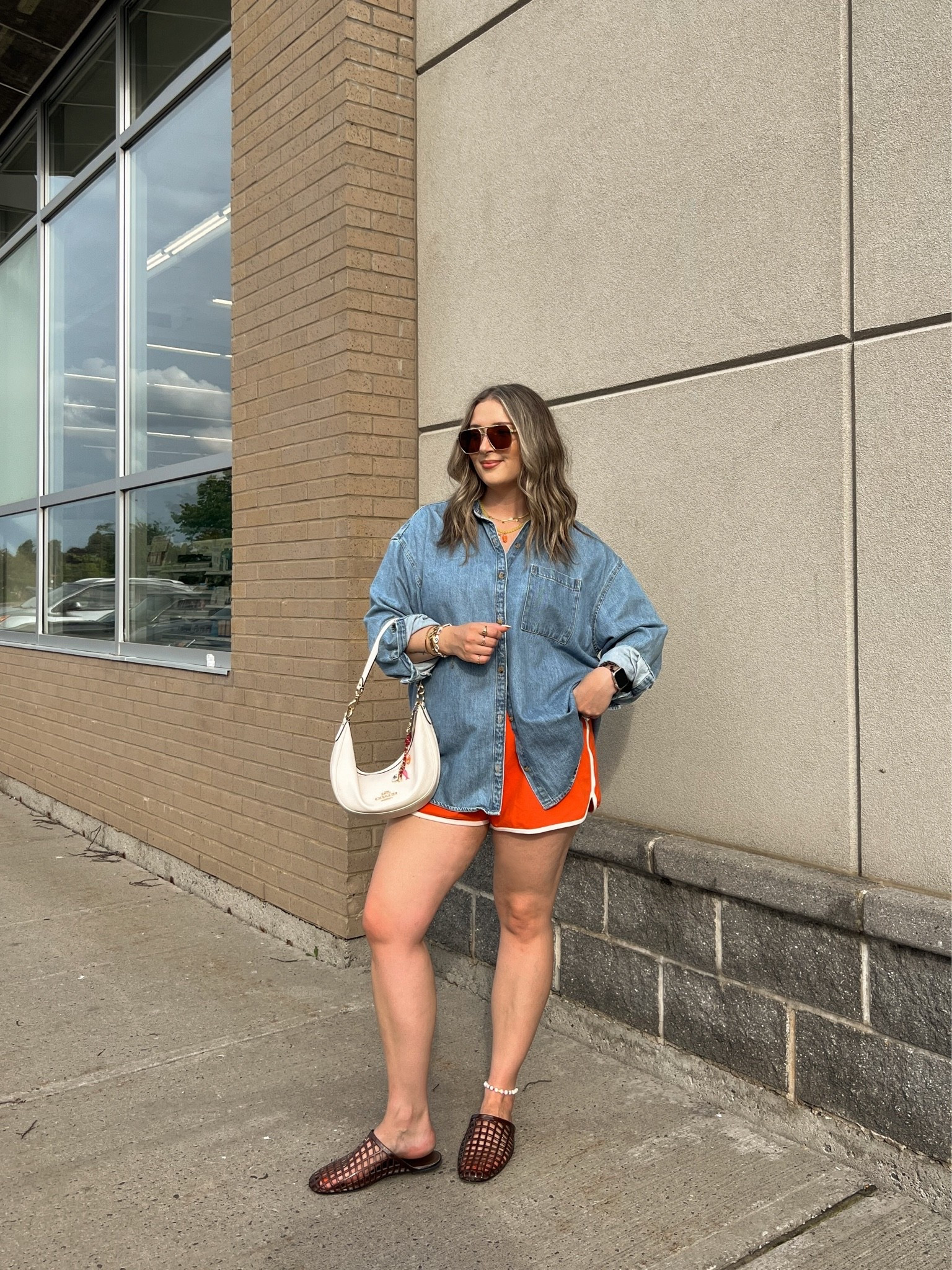 Casual summer outfit! Wearing my usual size L in the red orange dolphin shorts and my fave denim shirt. Jelly shoes are comfy and not sweaty, I’m a 9.5-10 and wear a 10. Canadian shirt and shoes link under “similar products”

#LTKsummer #LTKsale #LTKmidsize