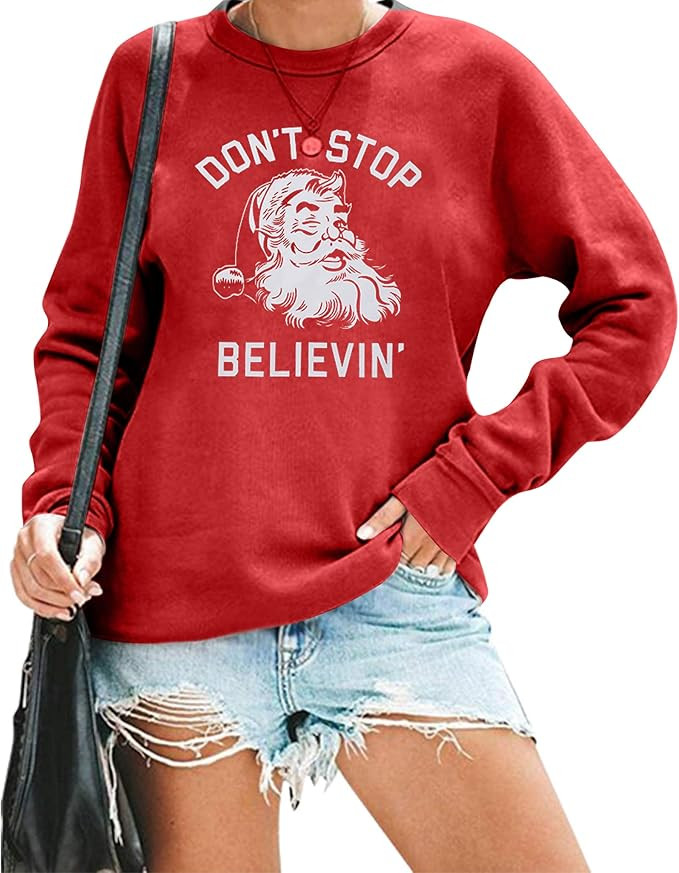 KIMSOONG Christmas Sweatshirt Women Don't Stop Believing Sweatshirt Funny Santa Garphic Tee Belie... | Amazon (US)