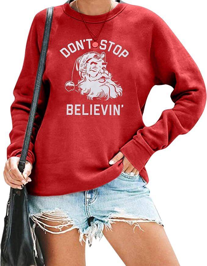 KIMSOONG Christmas Sweatshirt Women Don't Stop Believing Sweatshirt Funny Santa Garphic Tee Belie... | Amazon (US)