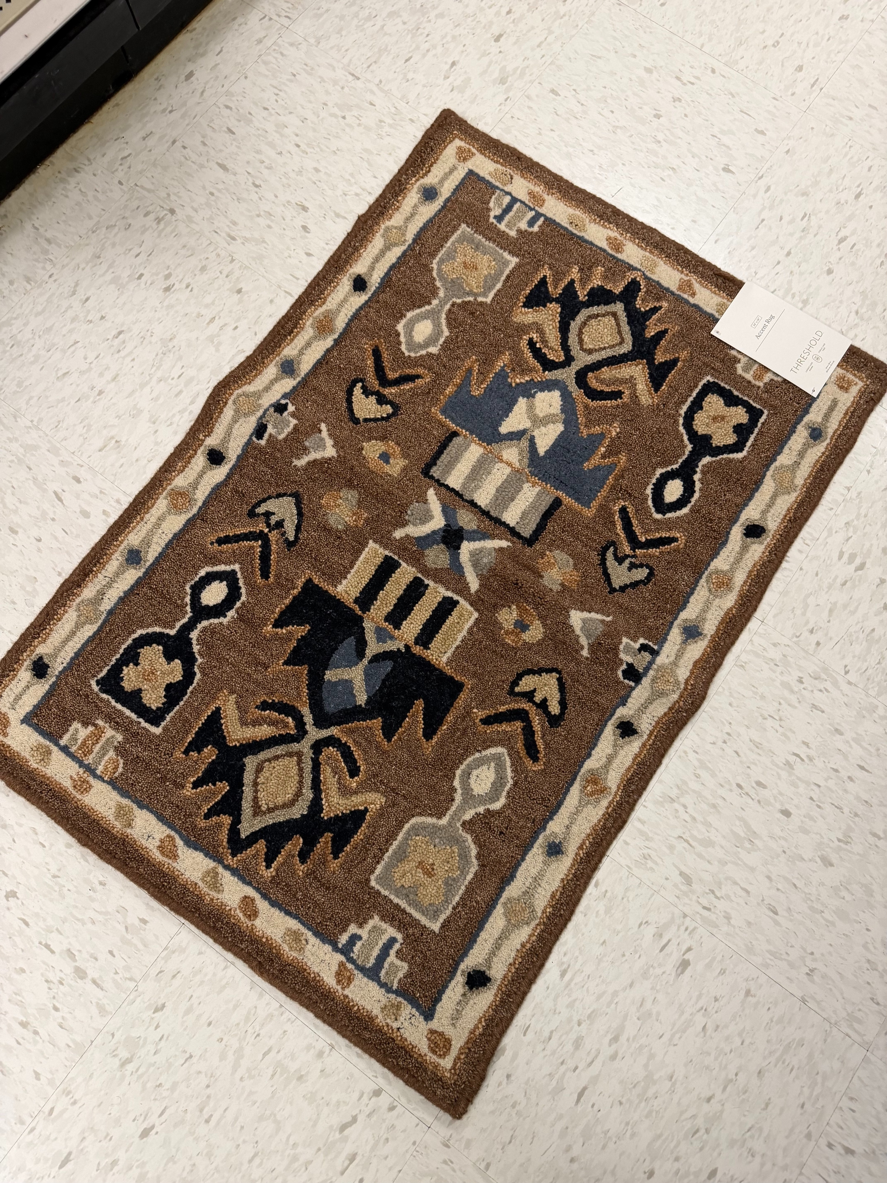 This Threshold wool tufted rug looks way more expensive than it is. It's a 100% wool rug with a hand-hooked geometric pattern in shades of brown, black, and tan, and it comes in a smaller accent size as well as a longer runner, starting at $25.50. I love how much texture and warmth it adds to a plain floor, and it photographs so much richer in person than it does online. This is exactly the kind of rug that makes an entryway or a small space feel finished without spending a lot. Linking both here so you can shop the rug in both sizes.

#LTKSeasonal #LTKHome #LTKSaleAlert