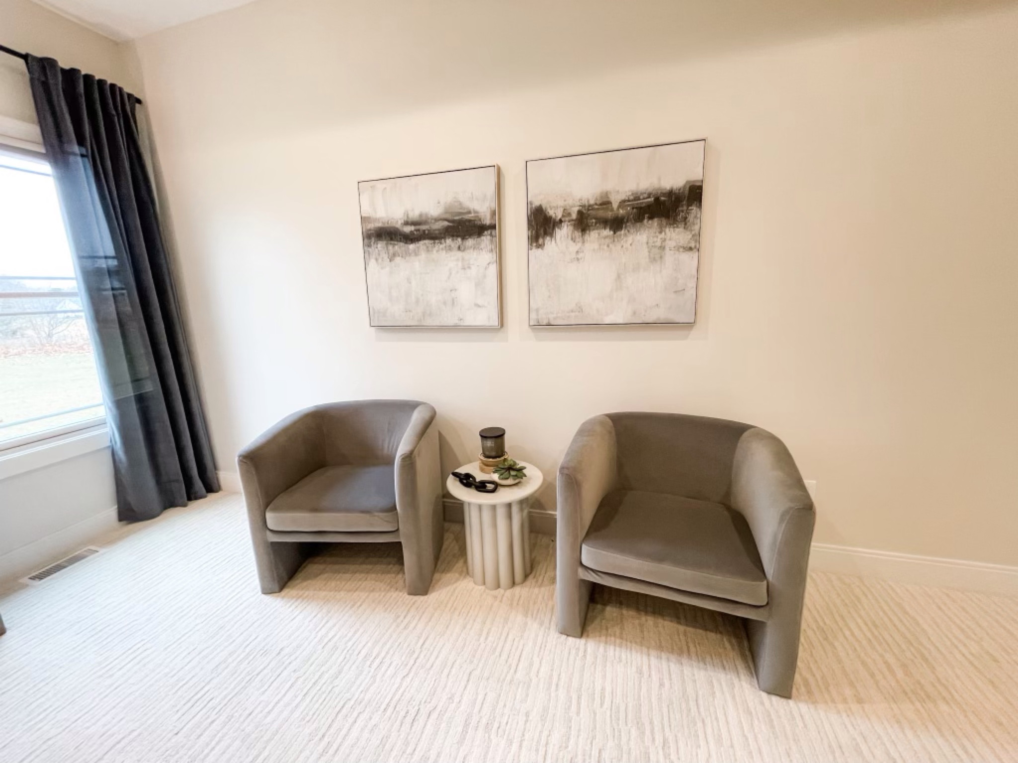 Target barrel chairs for the win! Paired nicely with round side table, abstract wall art, and blue curtains.

#LTKhome