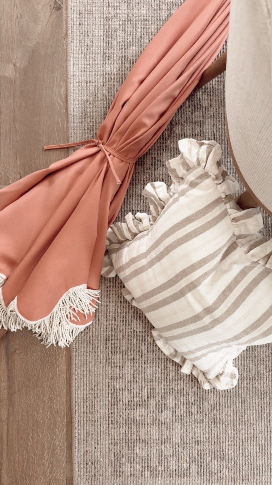 Loving this combo on our deck. The stripes and ruffles on the pillows are so cute with the print on the inside of the patio umbrella.

#LTKSeasonal #LTKHome