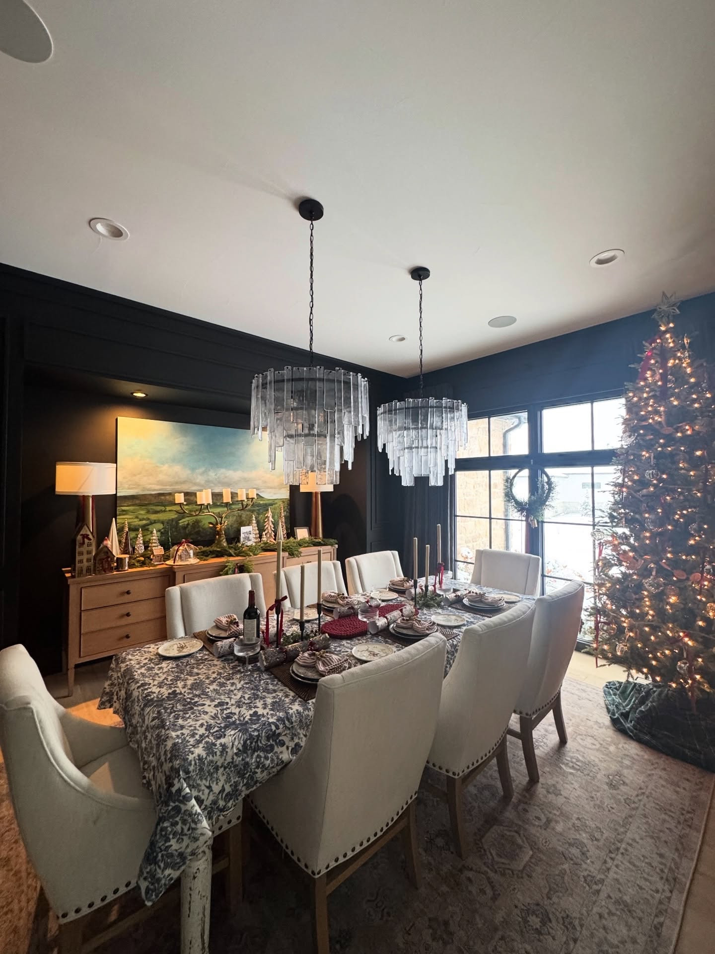 ✨ Moody holiday magic in the dining room ✨
Color-drenched black walls, a blue floral tablescape, candlelight, and nostalgic Christmas decor on the white oak sideboard. The reindeer stag and snowy backdrop make this space feel like a winter storybook scene. ❄️🌲
Keywords: nostalgic Christmas decor | moody holiday dining room | elevated holiday styling | designer Christmas inspiration | blue floral tablescape | timeless seasonal styling #interiordesign #christmastree #designbuild