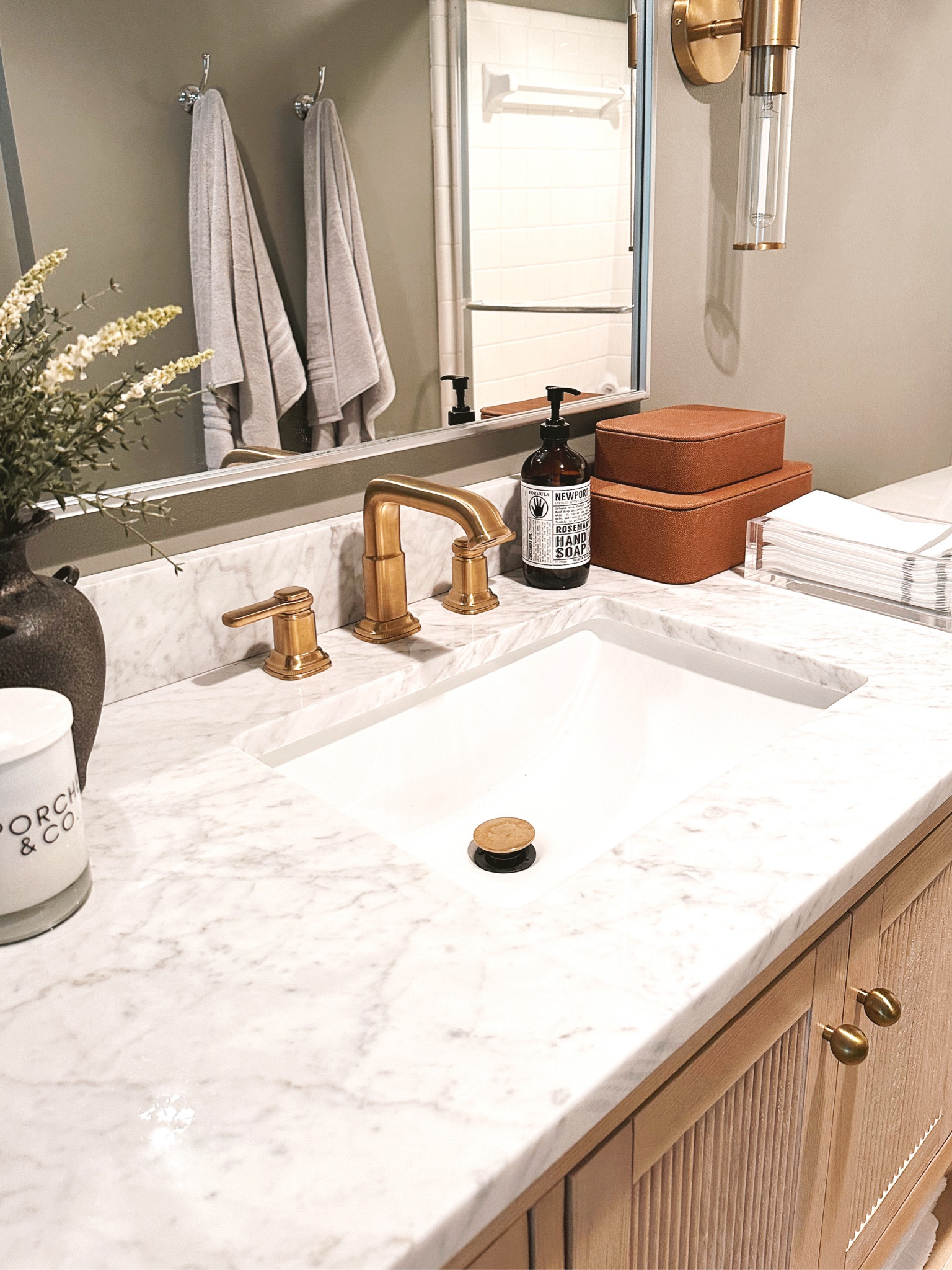 Bathroom makeover with the @homedepot complete with wooden fluted vanity with a cararra marble top, a brass modern faucet, plush bath towels, an arch mirror and gorgeous brass sconces- upgrade your home today with amazing Summer savings from The Home Depot 🤍 #bath #bathroom #thehomedepot #thehomedepotpartner #partner

#LTKSaleAlert #LTKHome #LTKStyleTip