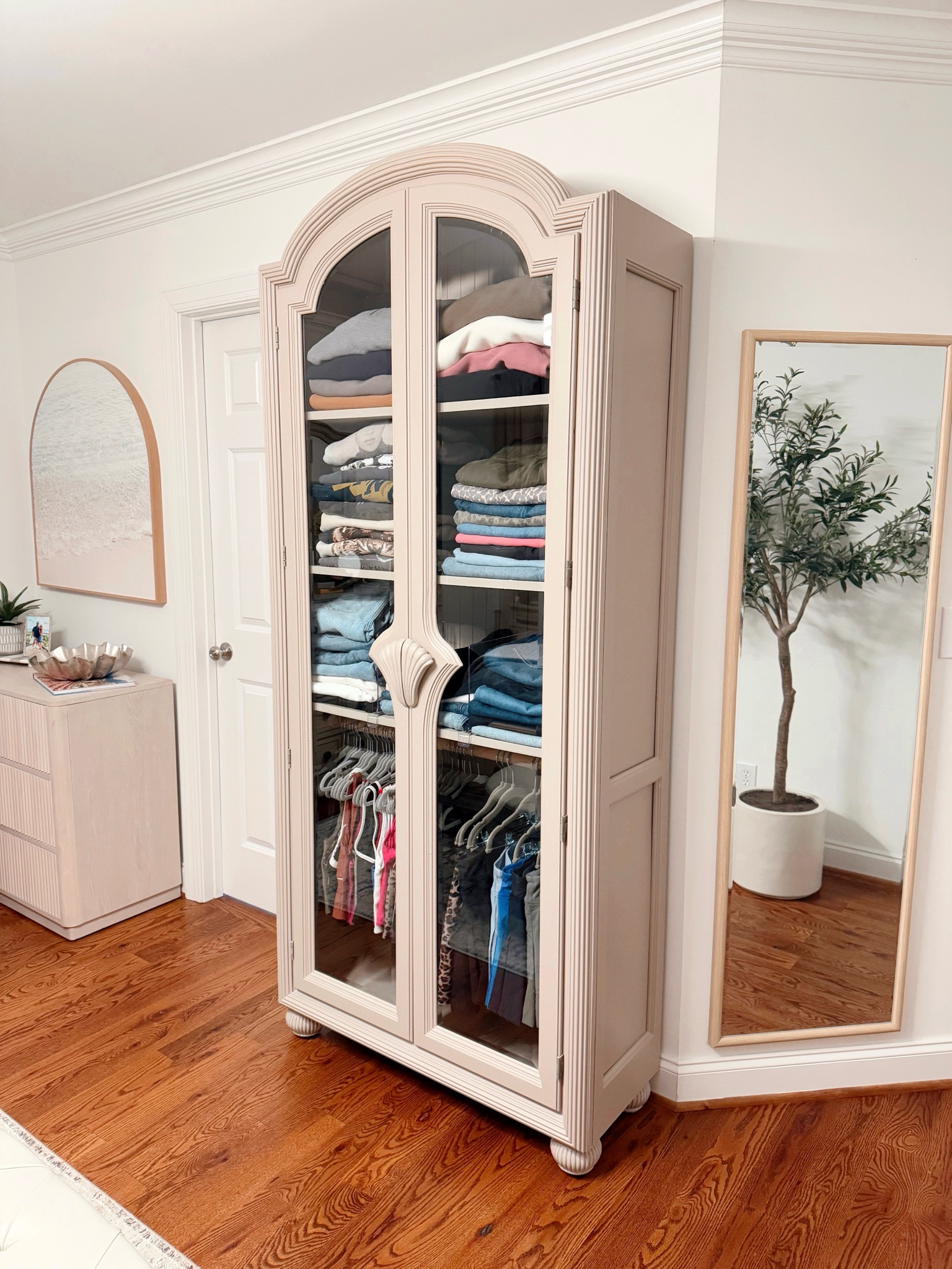 Oh how I love a glow up of a FB marketplace find! ✨😍 We got this Pulaski cabinet last Sunday and have been working on her all week! Our home definitely has a lack of closet space so we have to get creative! Michael’s clothes are in his office UPSTAIRS and his underwear is in his nightstand 😜🙃…so in an effort to shift some space around, I wanted to free up (a little 🙃) closet space and dresser drawers, so we turned this cabinet into a mini wardrobe! The paint 🎨 matches the rest of our bedroom furniture so it looks like it’s apart of the room! We removed all of the glass expect the front door panels and replaced them with wood!! 💁🏼‍♀️ It turned out better than I imagined! Also I think this is our 7th or 8th furniture re-make in a year! 🫶🏻 Tell me below if you love re-doing furniture too! 🤩 

Home decor, cabinets, DIY 

#LTKFindsUnder100 #LTKHome #LTKStyleTip