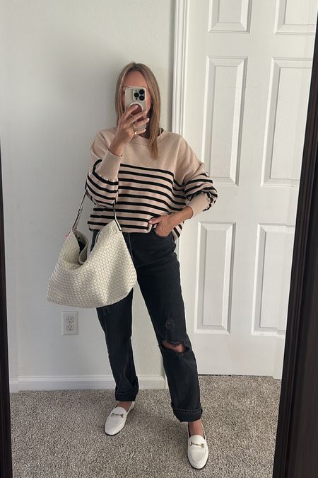 Casual outfit idea striped sweater and woven bag white loafers black jeans 