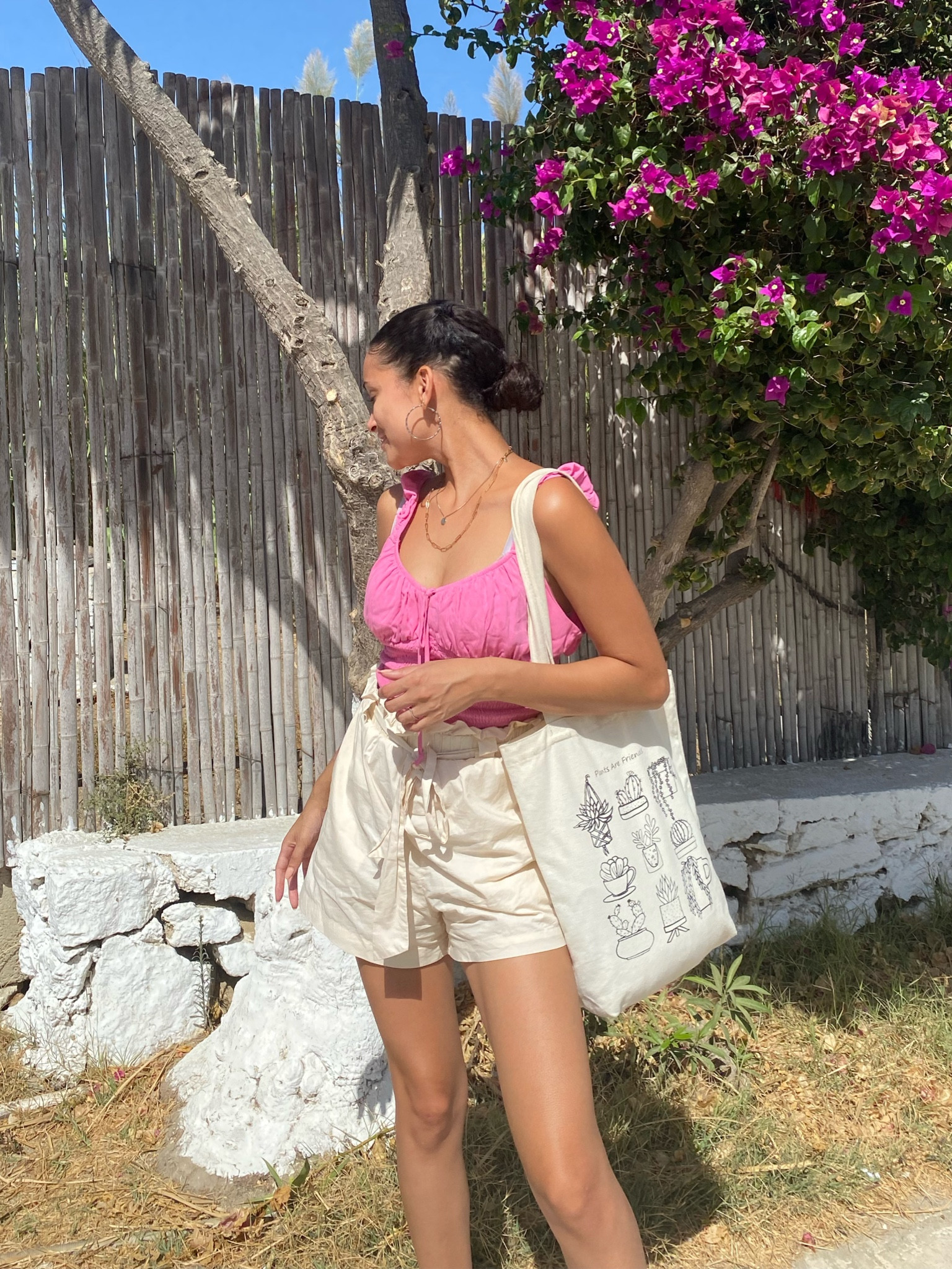 Summer outfit vacation style pink top pink cami tote bag cream shorts cloth shorts pink crop top vacation basics 
