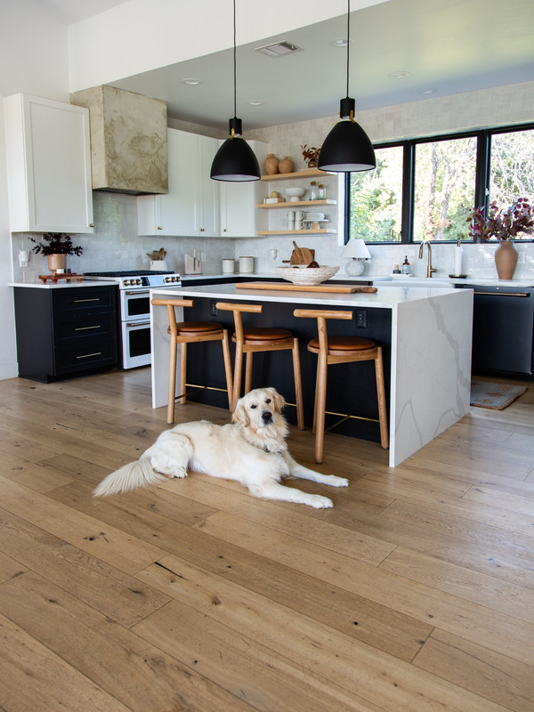 Even the kitchen feels fall-ready with natural wood barstools, a mix of stone and…