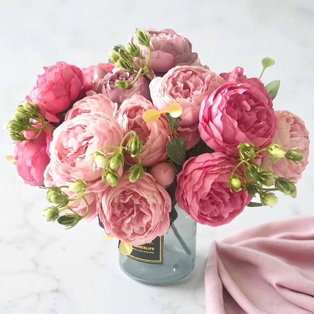 Soft, romantic, and effortlessly elegant, this pink peony silk bouquet adds instant beauty to any space. Featuring five full blooms and delicate buds, these lifelike flowers are perfect for weddings, centerpieces, home décor, or DIY arrangements that stay gorgeous year-round. A timeless floral accent without the maintenance.

#LTKHome #LTKStyle #HomeDecorFinds #SpringDecor #WeddingDecor #FauxFlowers #PeonyLove #FarmhouseDecor #FloralDecor #CenterpieceIdeas #WeddingInspo #HomeStyling #NeutralHome #RomanticDecor #LTKFinds

#LTKWedding #LTKHome #LTKSeasonal