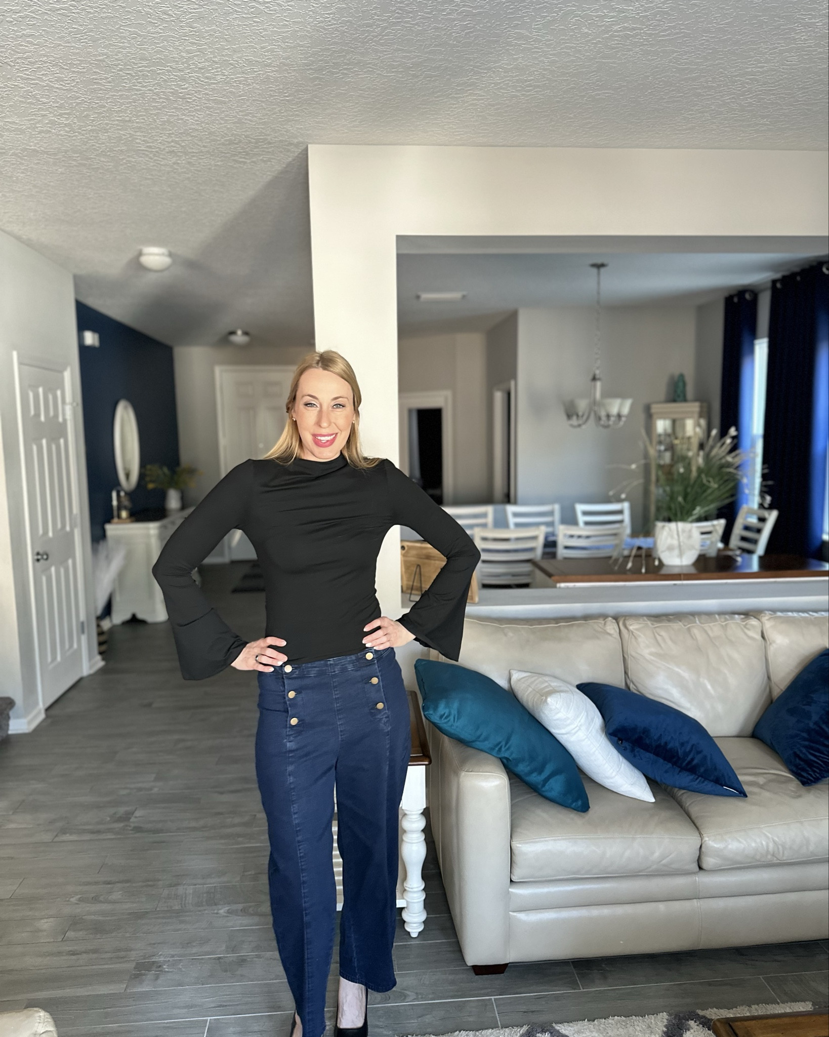 Feeling cute in black 
🖤 how fun is this top with the trumpet sleeves 
🖤  these pants are so cute. I love the double side buttons. They are kinda short on me but with heels they look good 
🖤 wearing size small, they both fit true to size and I am 5’10”

#LTKFindsUnder100 #LTKFindsUnder50 #LTKStyleTip