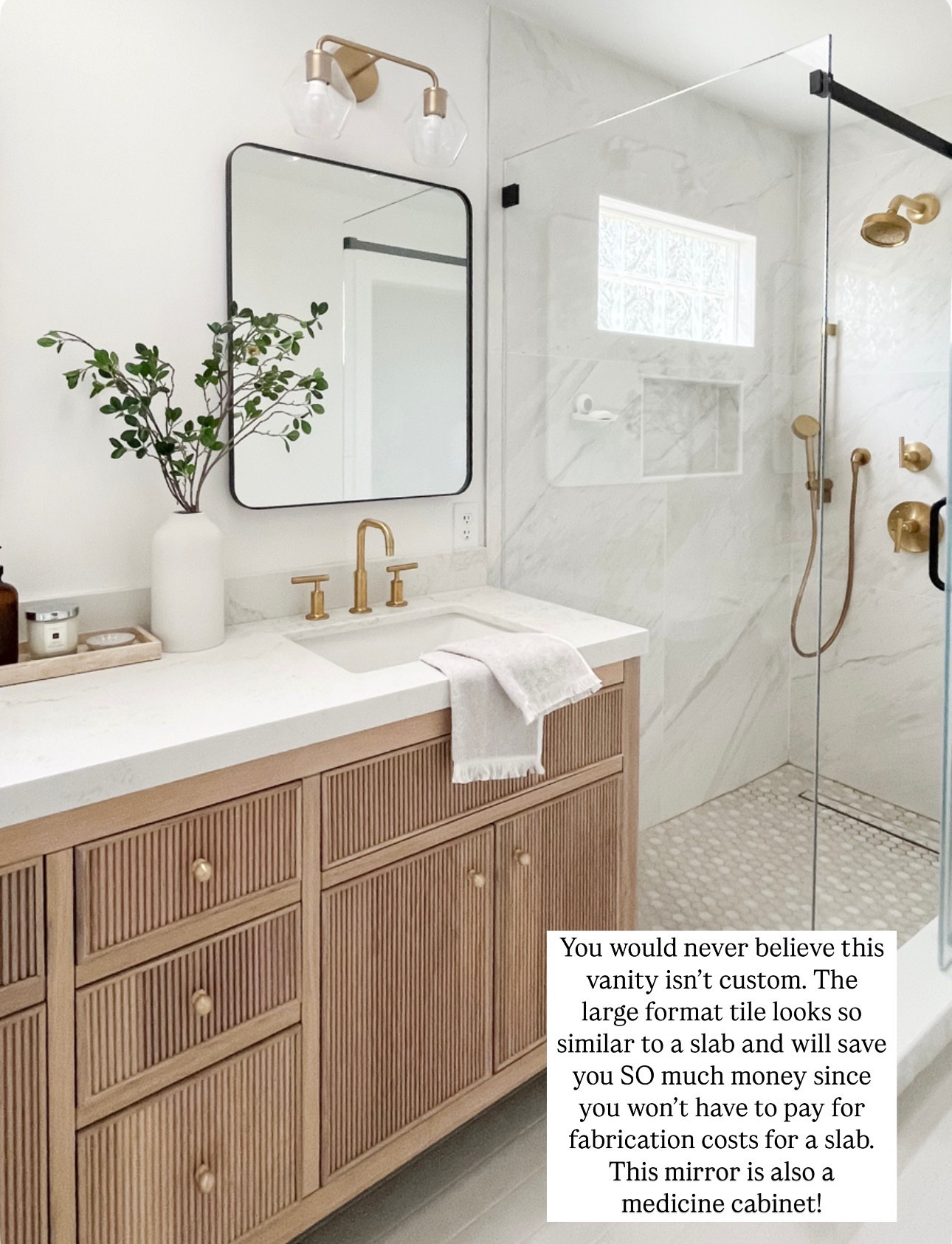 This entire beautiful bathroom is from @Wayfair. We used so many affordable options, yet were able to achieve this high-end look. Love the reeded detail of this prefab wood vanity, which comes with multiple different countertop options. My favorite part could be the medicine cabinet. So stylish and functional. Love how the neutral colors of the tile provide a serene vibe.

Marble tile, large format, tile, gray tile, wood, vanity, brass faucet, brass shower system, black rectangle, mirror, medicine cabinet glass, sconces, brass, sconces, glass, shower door, sliding glass door

#LTKFindsUnder100 #LTKSaleAlert #LTKHome