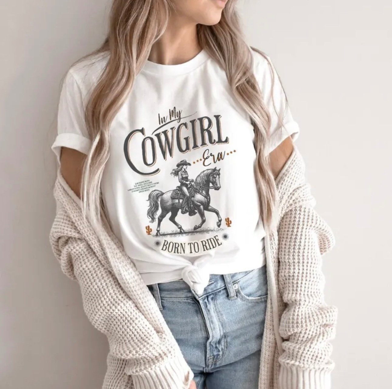 Step into your wild west era with this “In My Cowgirl Era” graphic tee — made for the rodeo queens, backroad dreamers, and country concert girls who were born to ride.

This ultra-soft unisex-fit T-shirt blends desert dreams with a bold western vibe, perfect for pairing with boots, fringe, and a whole lotta attitude. Whether you’re dancing at a country concert, wrangling weekend plans, or living that soft cowgirl life, this shirt is your new go-to.

Details:
	•	Soft + breathable cotton blend
	•	Unisex fit – size up for oversized look
	•	Professionally printed design (no vinyl!)
	•	Available in multiple colors

Great for:
Rodeo nights, bachelorette parties, Nashville trips, line dancing, western photo shoots, or just livin’ your best cowgirl era.

#cowgirlera #rodeooutfit #westerntshirt #concertshirt #roadeowear

#LTKSeasonal #LTKStyleTip #LTKMidsize