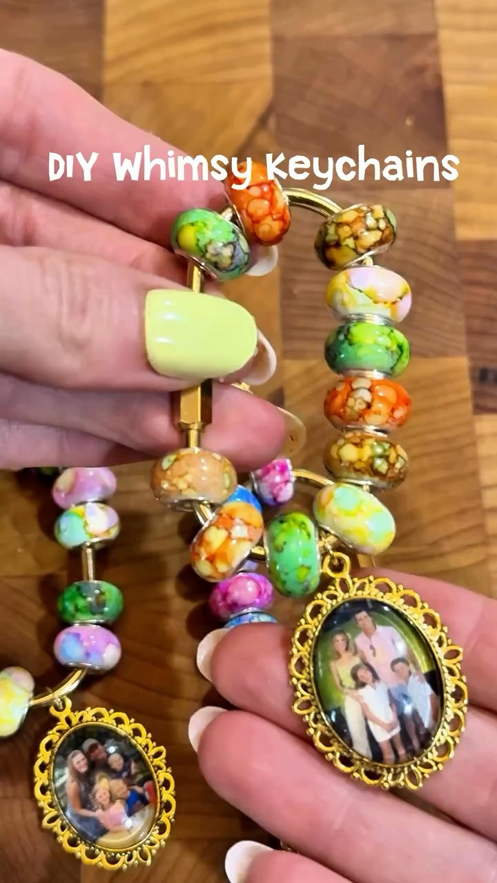DIY whimsy keychains are trending this summer and I’m officially addicted. ✨🐟🎀

Follow @mackenziebiehl for easy hosting and whimsy DIYs. Comment KEYCHAIN for details.

The key rings clip onto purses, dog leashes, backpacks… literally anything. They come with a gold ring set, but I wasn’t crazy about the size, so I swapped them for smaller rings from my jewelry-making supplies.

For the photo pendants, make sure you print on photo paper, not regular printer paper. I used my Canon printer with 4x6 photo paper, fit 4 photos onto one page, and scaled them to 10%. Then I used E6000 glue to secure the photo into the pendant and pressed the dome over top really firmly so there weren’t any bubbles.

I also used resin beads with large holes so everything slid on easily and felt a little more playful and chunky. The more random and layered they look, the cuter they are honestly.

Linked some adorable teacher inspired charms too if you're making for end of year! #easydiys #girlscrafts