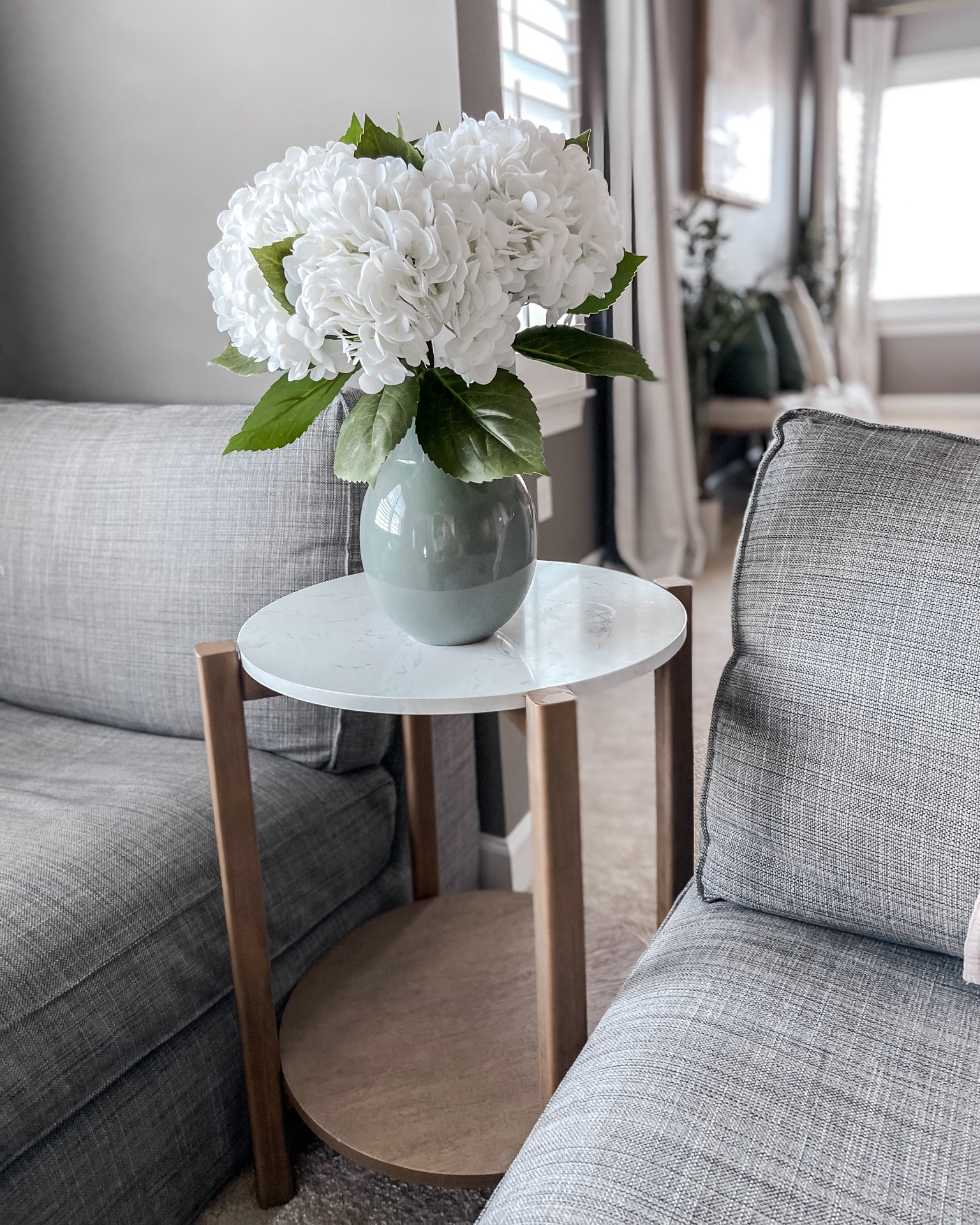 Realistic faux hydrangeas
Blue-Green Vase
Affordable Faux Marble and wood round side table

#LTKhome