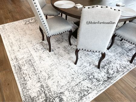 Our neutral area rug in the dining room kitchen area. Faded rug, distressed rug, black and white rug. Our dining room chairs. Ideas for round wooden farmhouse tables. Dining room table. Kitchen table.

#LTKhome