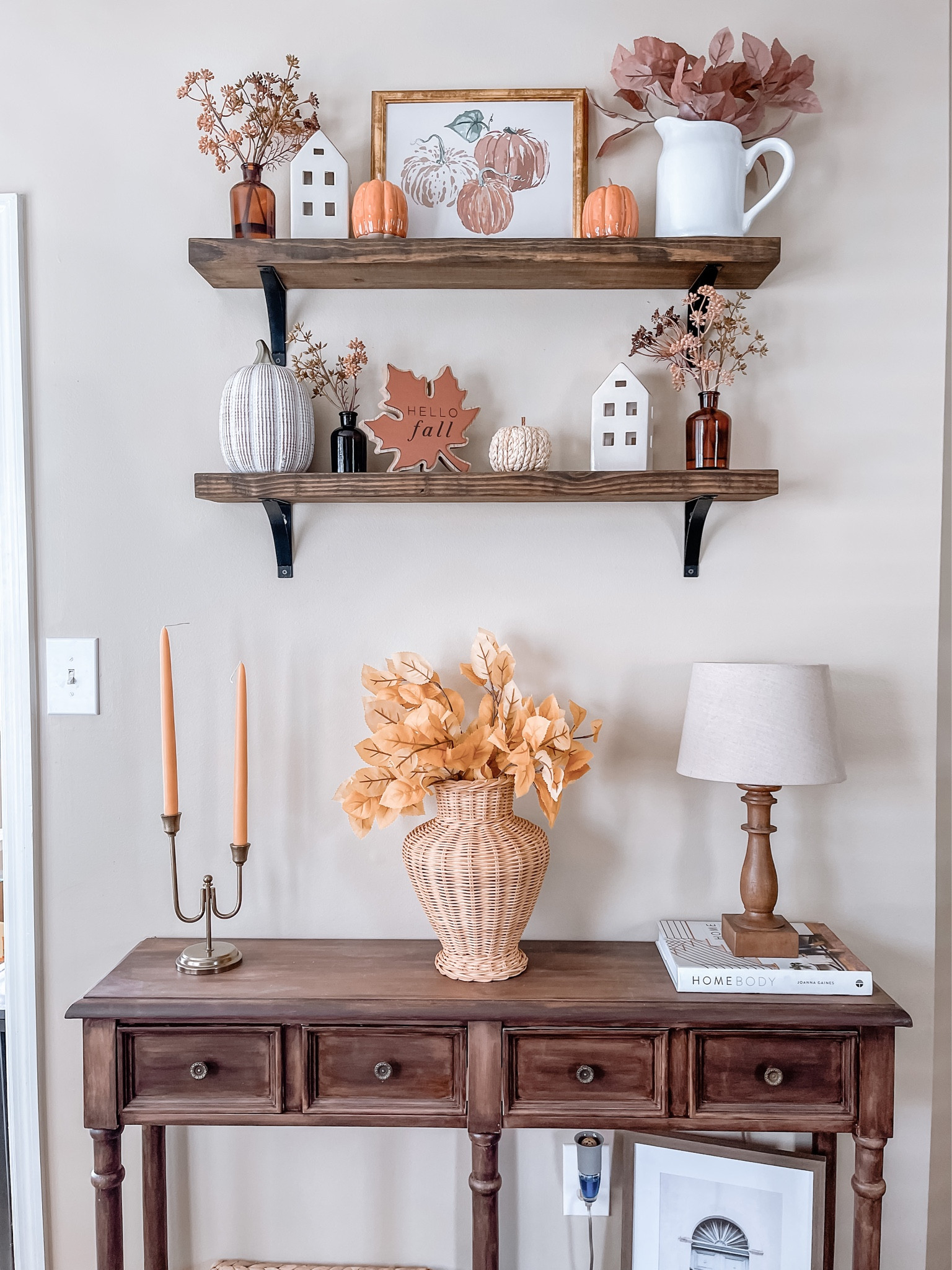 Fall styled floating shelves with floral stems and amber glass jars, pumpkin artwork, golden candelabra fall home decor fall decorating ideas fall decor home decor shelf styling 

#LTKhome #LTKSeasonal