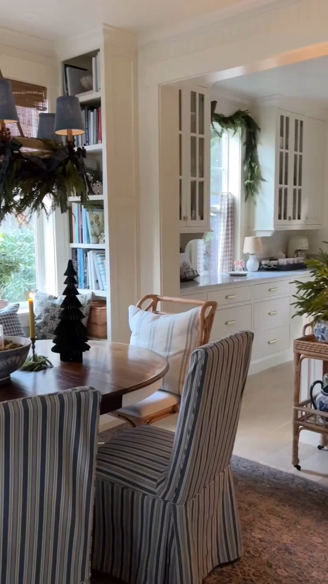 Our cozy cottage at christmas 🎄 paper trees, rattan cart, portable lap, chandelier, garland, cafe curtains, rug, striped sofa, bamboo shades and more 

#LTKHoliday #LTKSaleAlert #LTKHome