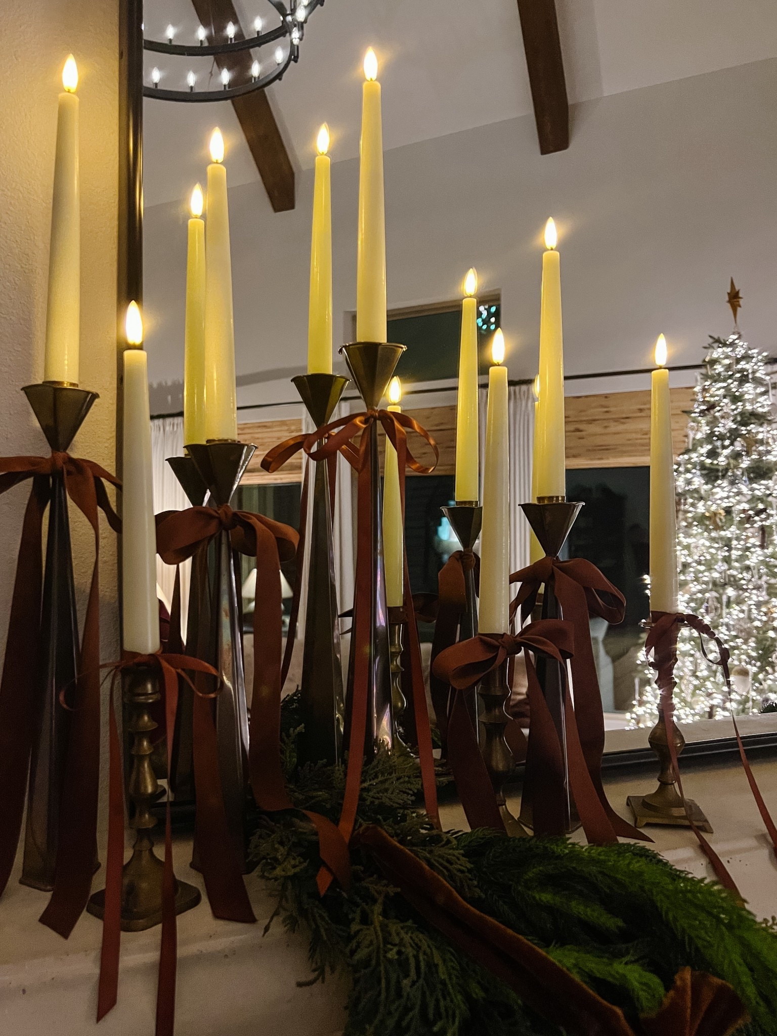Vintage brass candlesticks and bows are always in style when it comes to Christmas decor ✨ 

Add these flameless battery operated candles with timers and you’ll always have a beautiful, worry free glow 🕯️ 

I used a mix of brown satin and velvet ribbon to create the bows