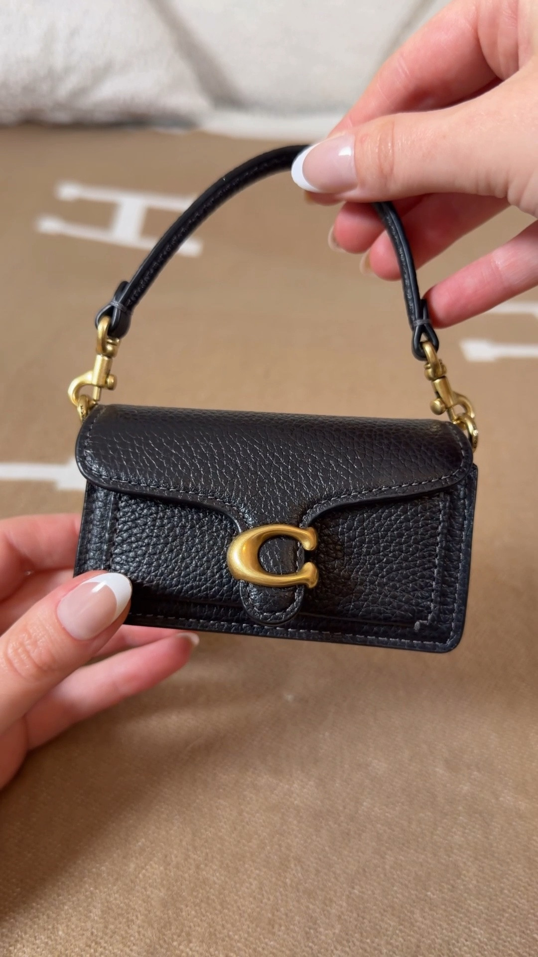 What fits in the Coach Mini Tabby Charm 🖤

This little bag is too cute! It comes with a short strap so you can attach it to bigger bags as a bag charm or it comes with a chain so you can wear it as a mini crossbody bag to hold you lip gloss 💄

I packed my mini Tom Ford Lipstick and mini Rare Beauty liquid blush and some mini tictacs