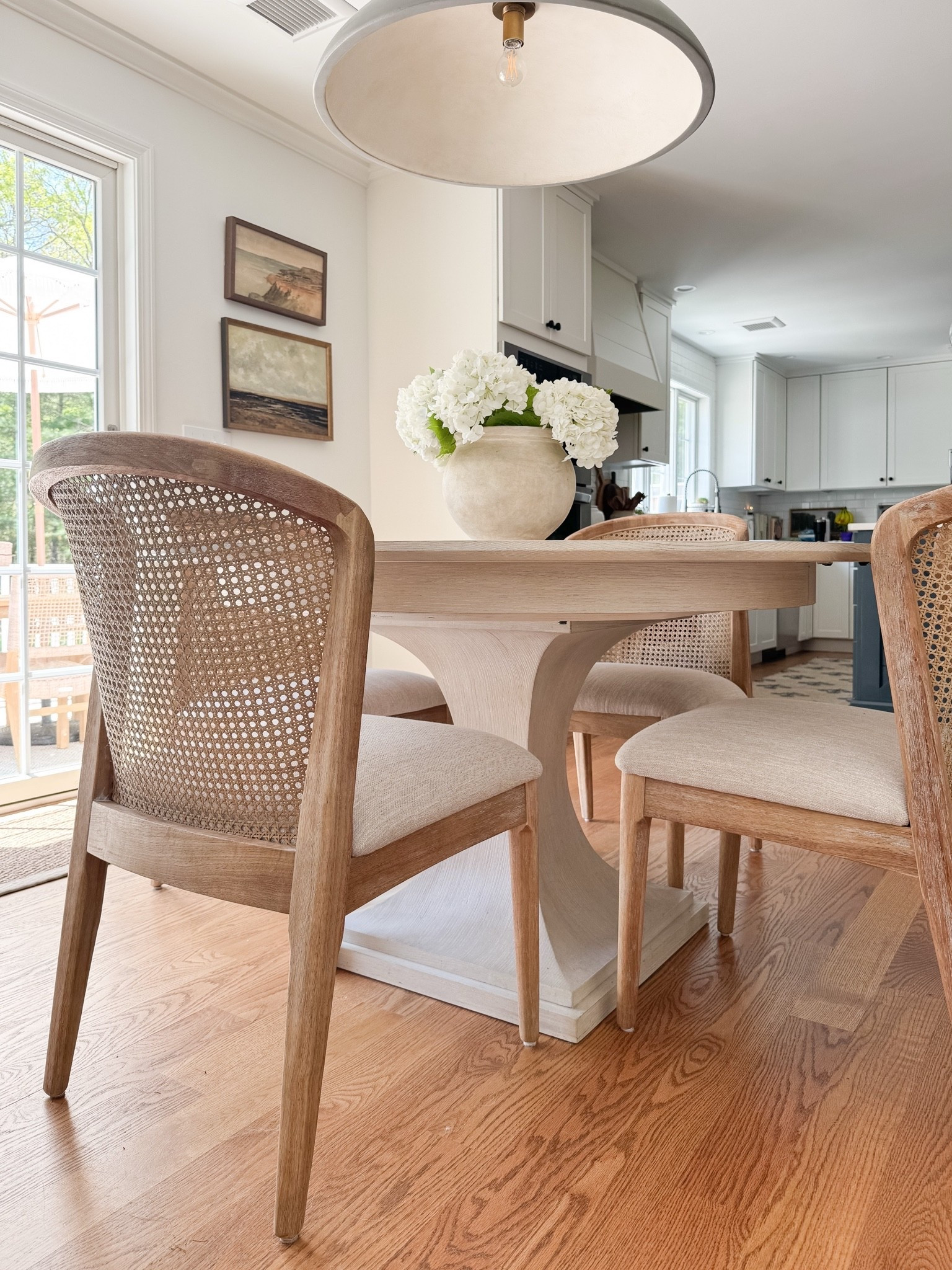 coastal dining room decor, round wood dining table, woven dining chairs, faux hydrangea centerpiece, neutral dining room styling, coastal interior decor, light coastal home, neutral dining room inspiration, sherricalnanhome

#LTKHome