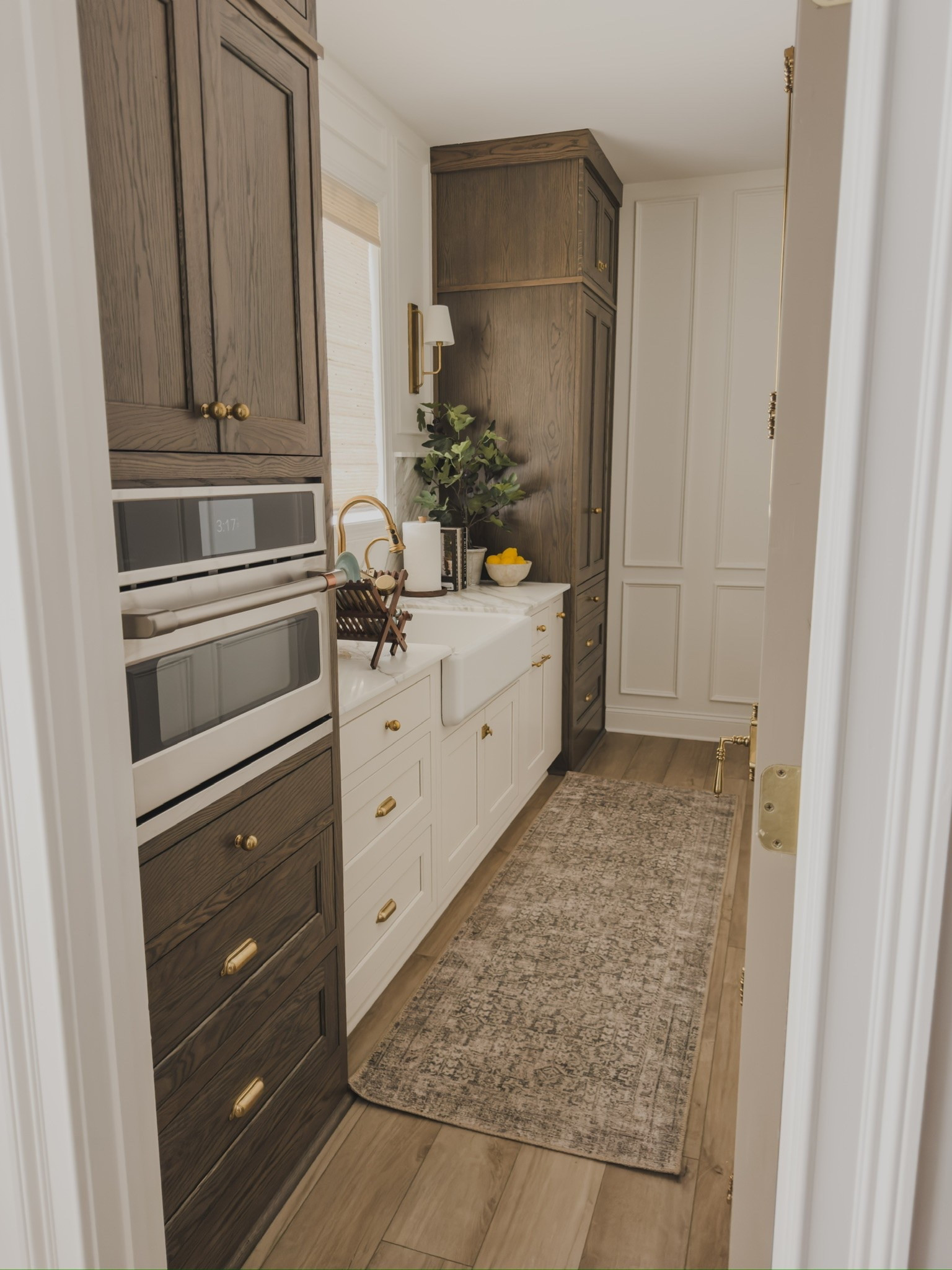 Recent views of my prep kitchen combining classic wood tones, creamy whites, and a vintage style rug runner for a timeless and collected feel.

Home finds, neutral home inspo, collected style, prep kitchen views, summer style, neutral fall transition, classic wood tones, vintage style area rug, bamboo shades, unlacquered brass detail, wooden dish rack, brass wall sconce, brass faucet, Cafe, Rejuvenation, Kohler, faux olive tree, Two Pages, found it on Amazon, Wayfair, shop the look!

#LTKSeasonal #LTKHome