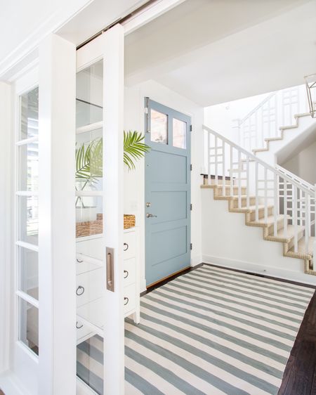 Our Omaha entryway decorated for summer with a white glossy raffia cabinet, blue and cream striped rug, lantern pendant light, “It Is Well” canvas art, tall thin black framed mirror, faux palm leaves and a paint dipped vase.

#ltkhome #ltkseasonal #ltkstyletip #ltkfindsunder50 #ltkunder100  coastal decorating, foyer ideas, blue and white

#LTKSeasonal #LTKfindsunder100 #LTKhome