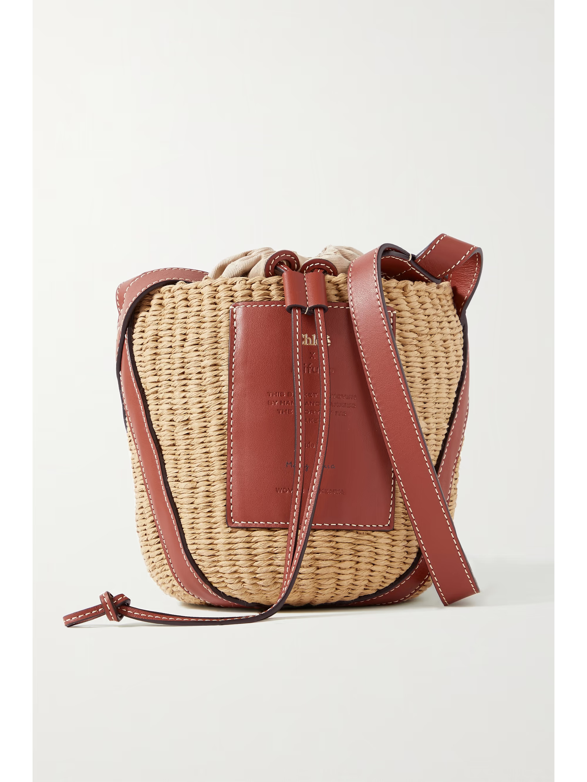 + NET SUSTAIN leather-trimmed raffia bucket bag | NET-A-PORTER (UK & EU)