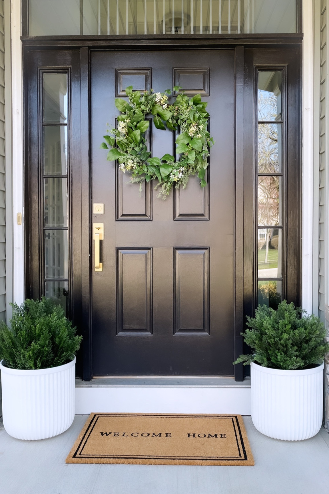 Spring front door decor: wreath, cedar artificial bushes, welcome mat, gold hardware. white fluted planters 

#target #walmart #amazon  

#LTKstyletip #LTKhome #LTKSeasonal