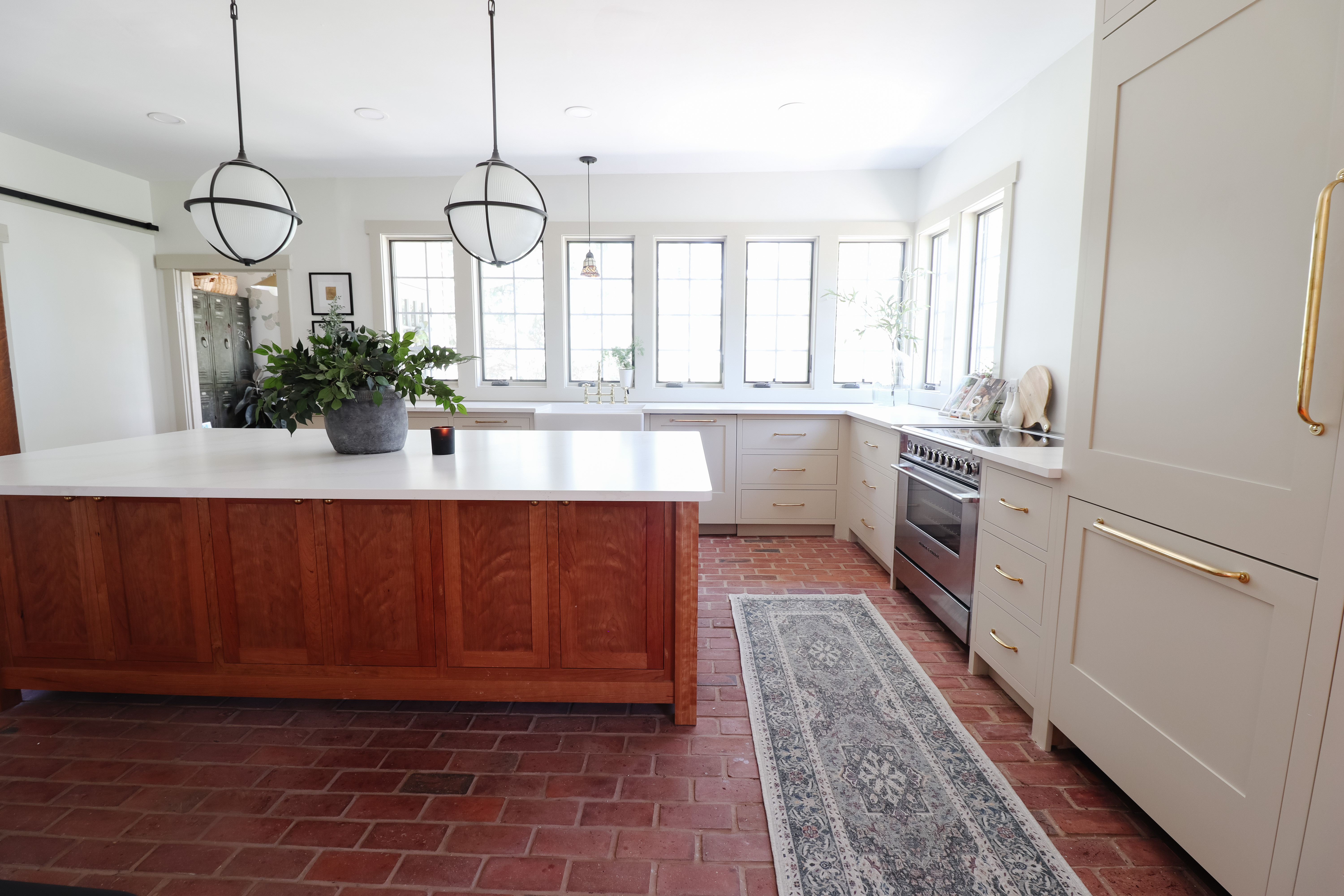 Kitchen renovation details I still love. Brick floors, a warm wood island, globe pendant lights, and brass cabinet hardware. 

 #LTKHome