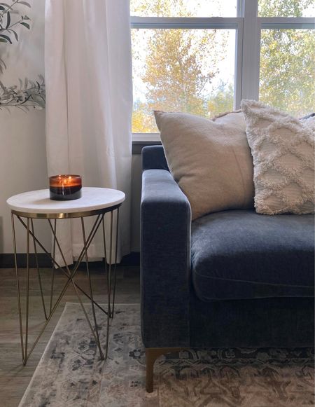 Cozy minimalist home decor 🤍 throw pillows, candle, end table, sectional sofa, white curtains, area rug, olive tree. 

#LTKhome #LTKSeasonal