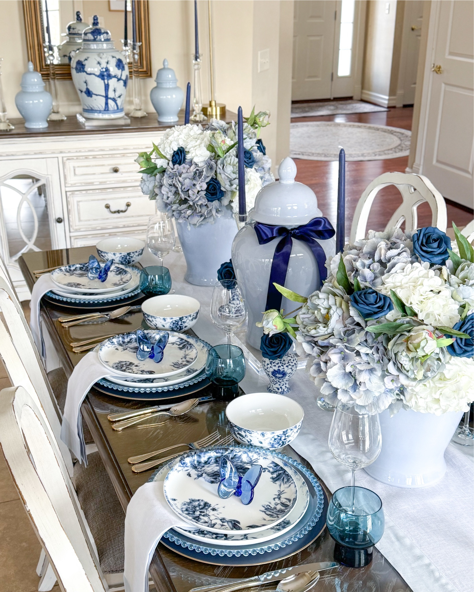 Shop my “Fluttering Moments” Mother’s Day Tablescape featuring the Pippa Blue collection from Mikasa! I love these crystal butterflies as party favors- they are a designer dupe and much more affordable!

Blue and white decor, blue and white tablescape, light blue ginger jar, chinoiserie, crystal butterflies, designer look for less, Amazon finds, blue and white dinnerware, blue and white plates, blue glassware, old fashioned glasses, crystal candleholders, faux hydrangeas, blue hydrangeas, white hydrangeas, navy roses, dining room decor, entertaining ideas, party ideas, elegant style  

#LTKSeasonal #LTKHome #LTKParties