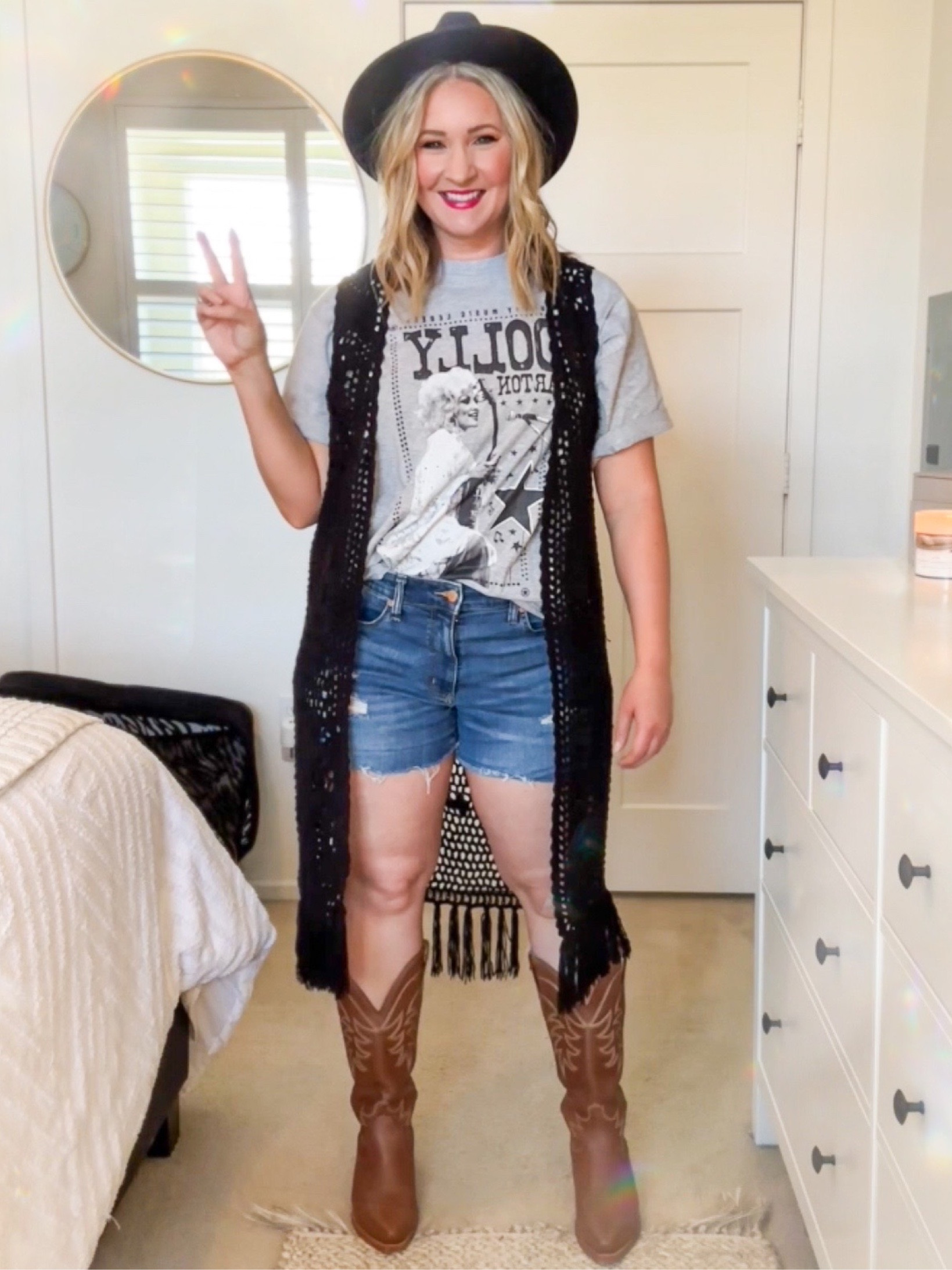 This Dolly Parton shirt makes for the perfect Nashville Outfit! 🖤 Paired with black flat rim hat, jean shorts, tecovas cowboy boots, and black knit duster  

#LTKstyletip #LTKFind #LTKSeasonal