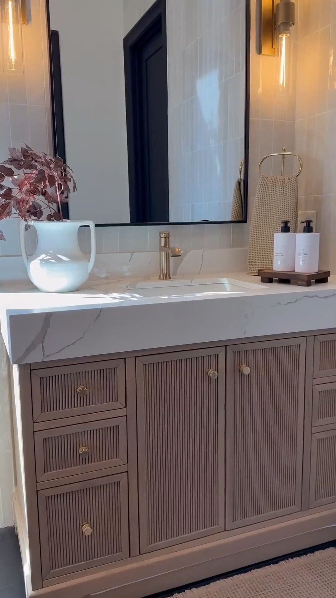 My bathroom vanity feels so warm and inviting with a few seasonal accents like these cimicifuga stems 🌿 The brown accent chair adds the perfect cozy tone 🪑 and I love how the backsplash and vanity combo keep everything neutral while still adding warmth 🤍

My artwork has been such a favorite 🎨 available in so many sizes and styles, it’s perfect 🤩 I’m also obsessed with my white oak console and dining tables that carry that same warmth throughout my home. And this vintage-inspired vase is so versatile, it works beautifully as a planter and adds that timeless look.🏺✨