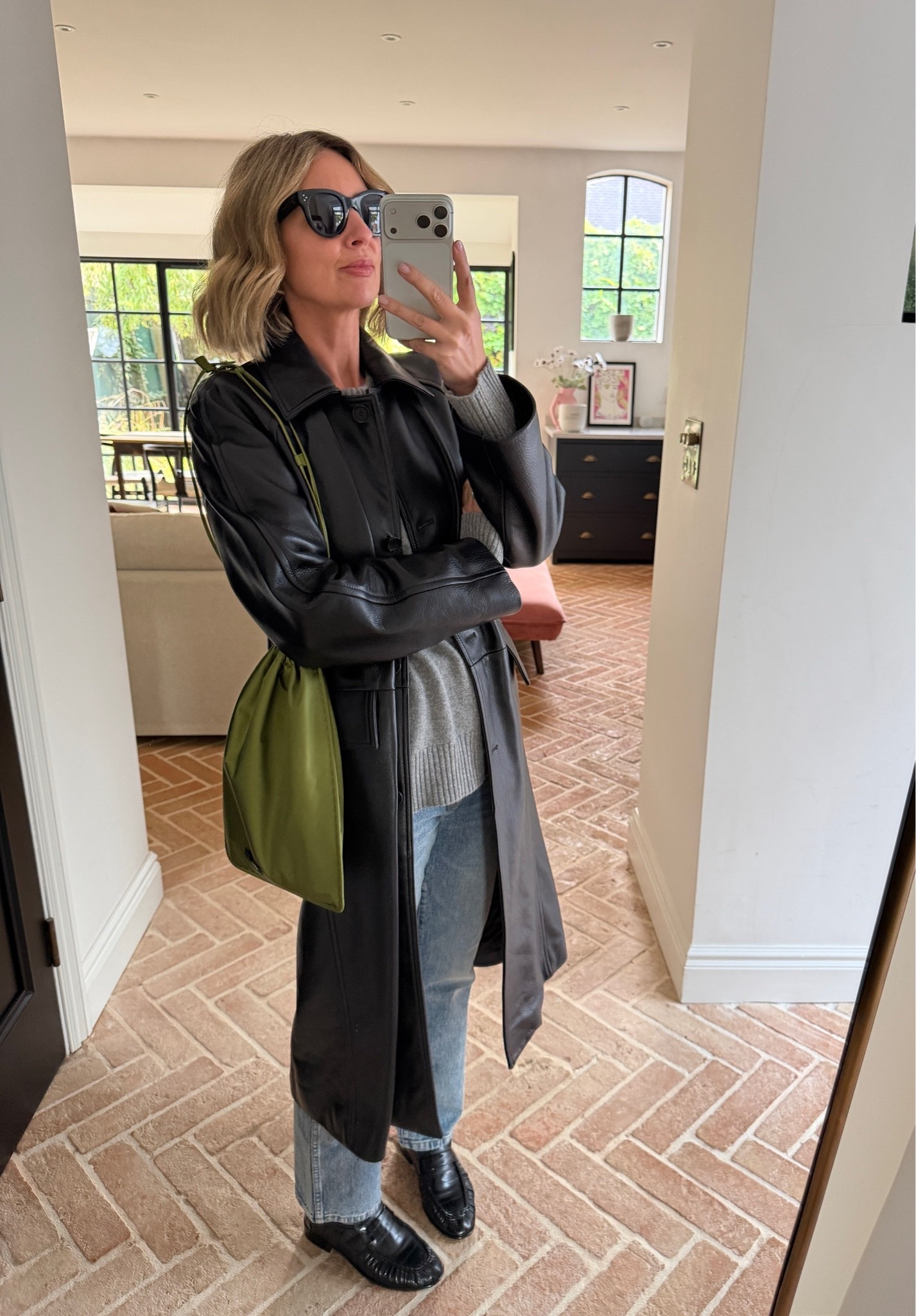 🖤

black leather trench coat, belted leather coat, grey knit sweater, light wash jeans, black leather loafers, olive green shoulder bag, black cat eye sunglasses, casual chic outfit, autumn transitional dressing, statement outerwear, elevated basics, quiet luxury, neutral color palette, mirror selfie ootd, ltkstyletip, ltkseasonal, ltkfindsunder100, ltkitbag